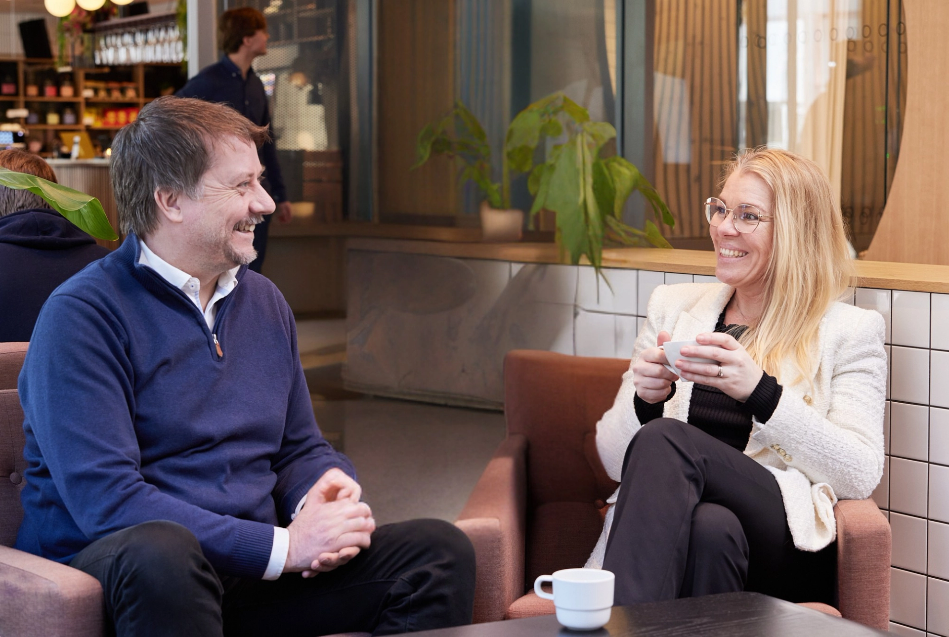 A man and a woman smiling at each other.