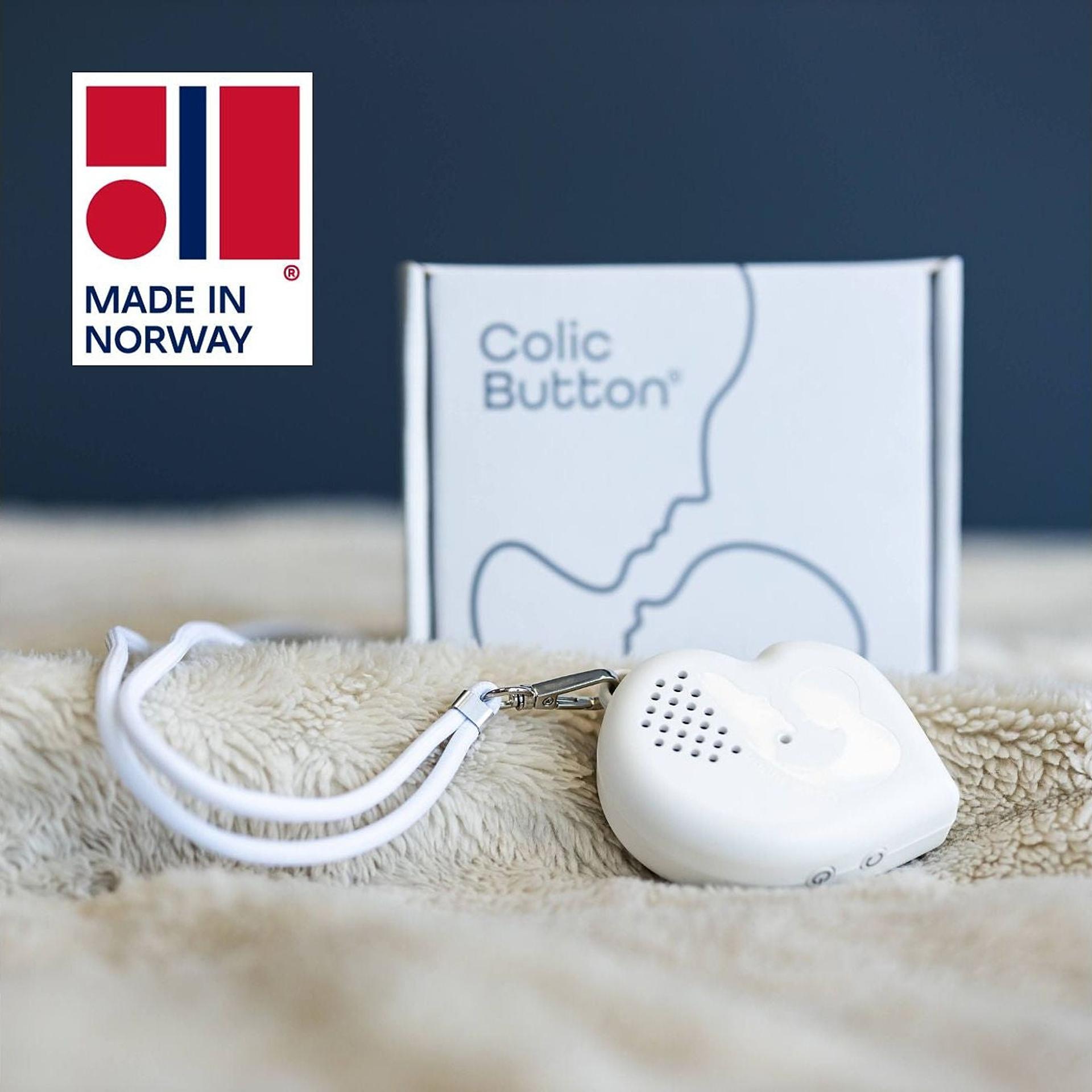 A colic button and the packaging, with the Made in Norway label.