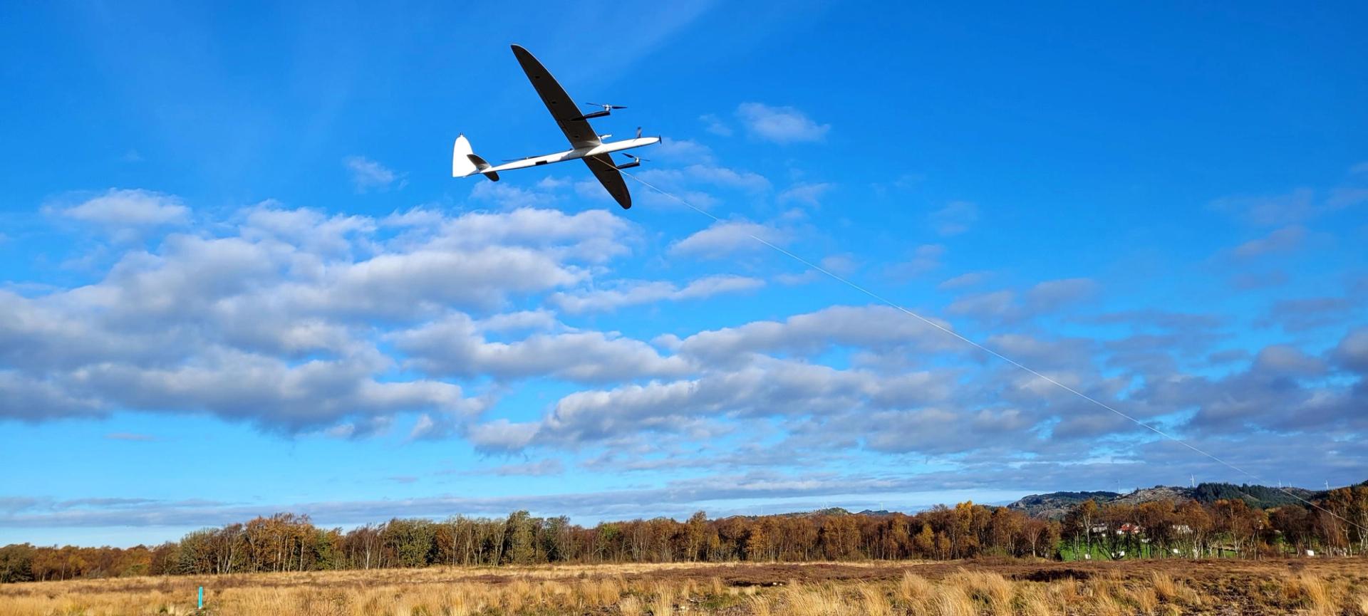 Wind energy kite flying against a blue sky