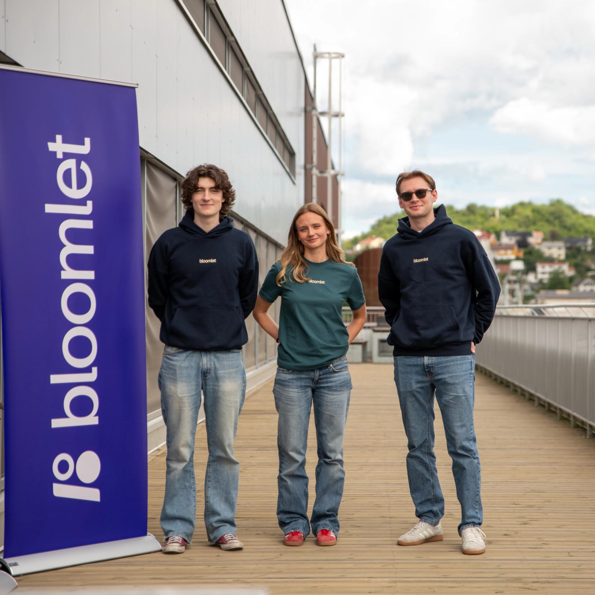 Bloomlet employees standing outdoors smiling at the camera