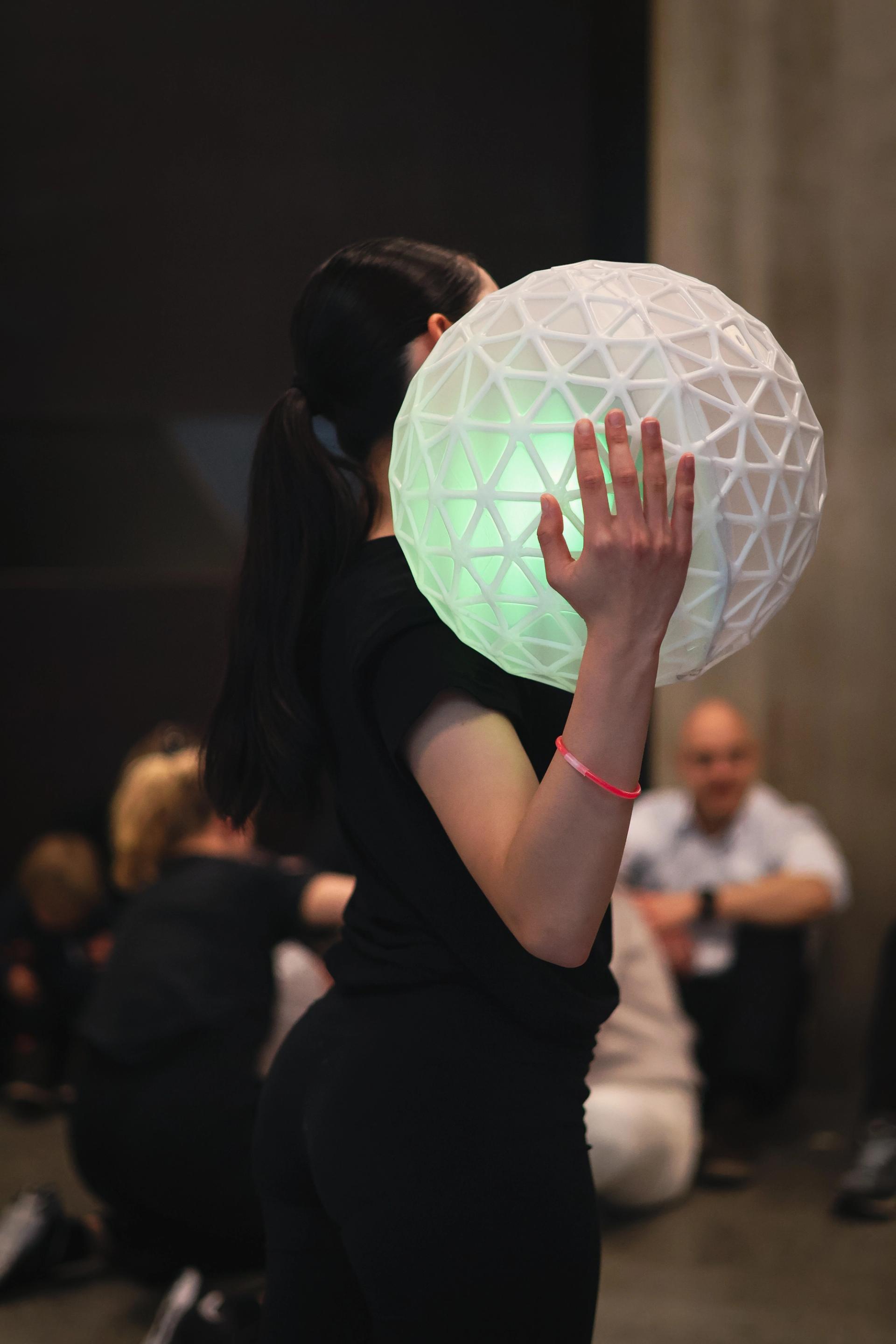 A woman holding the Muzziball