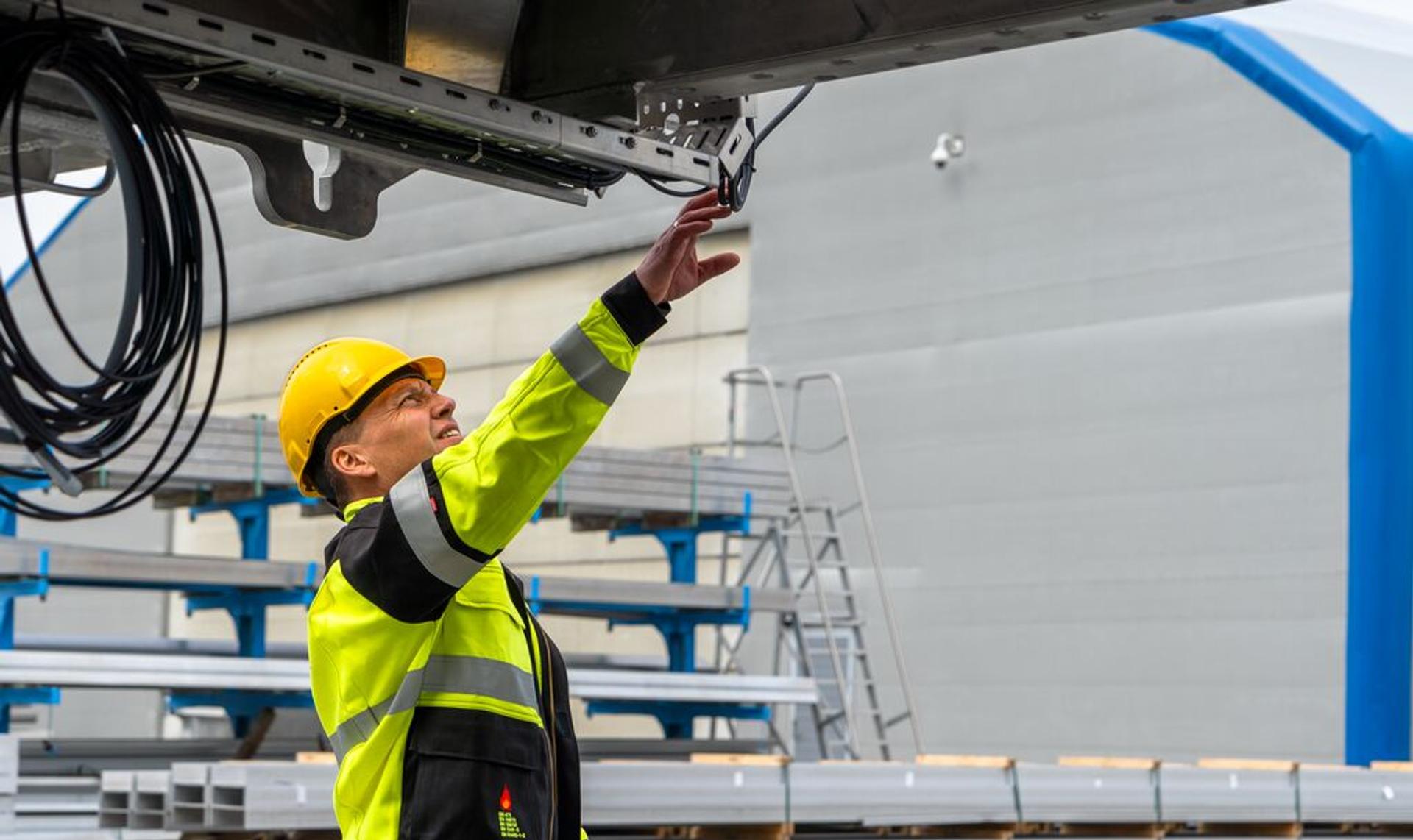 Worker inspecting a metal gangway