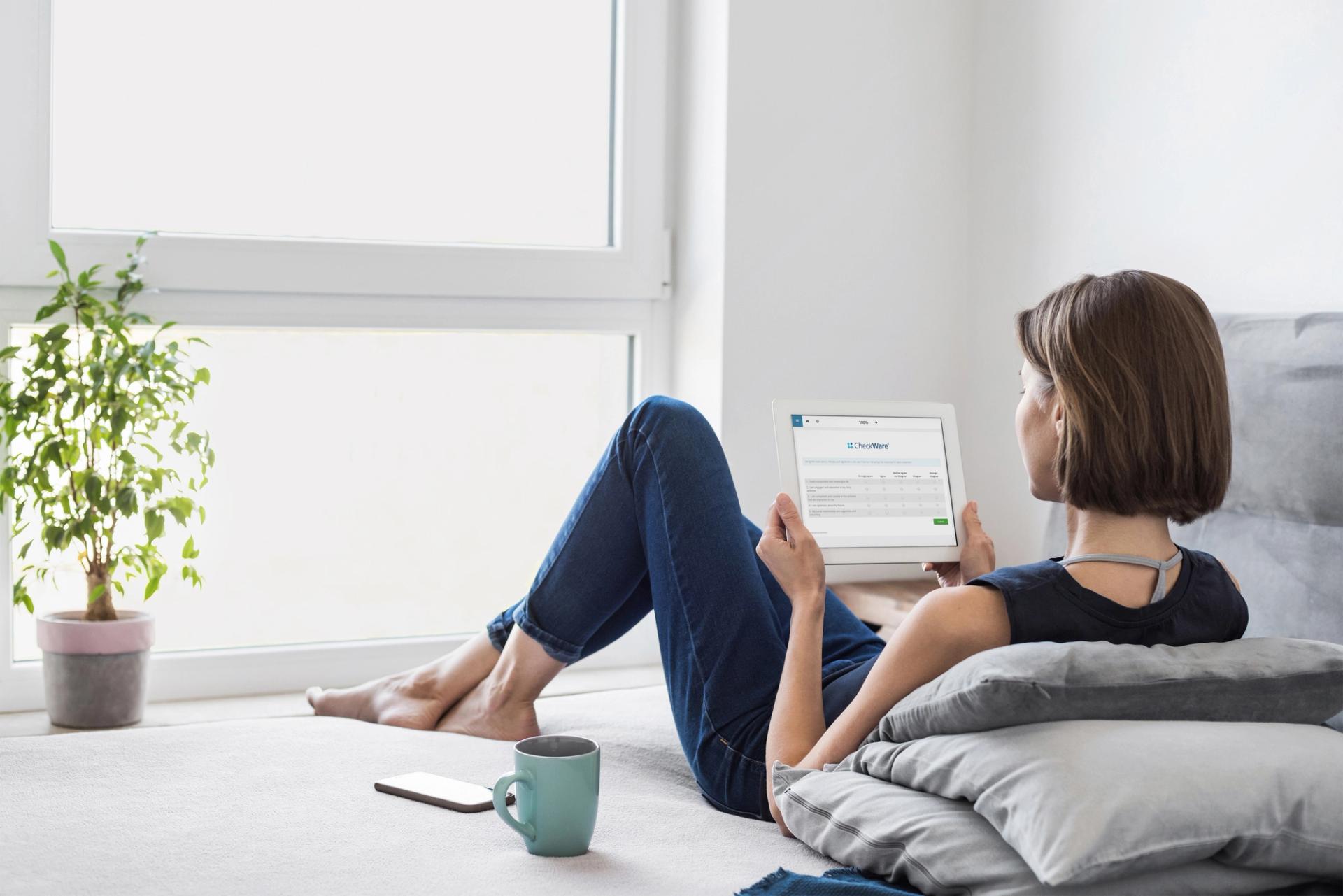 Woman in couch using iPad
