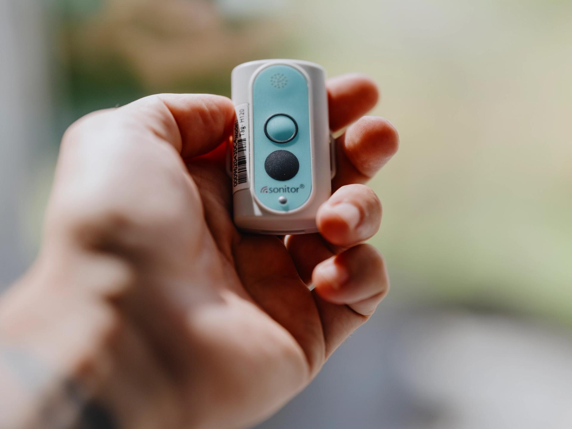 Man holding a small call button