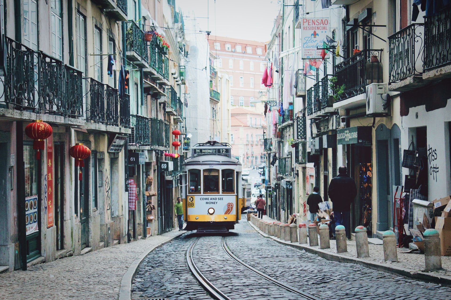 tram through narrow streets in Lisbon