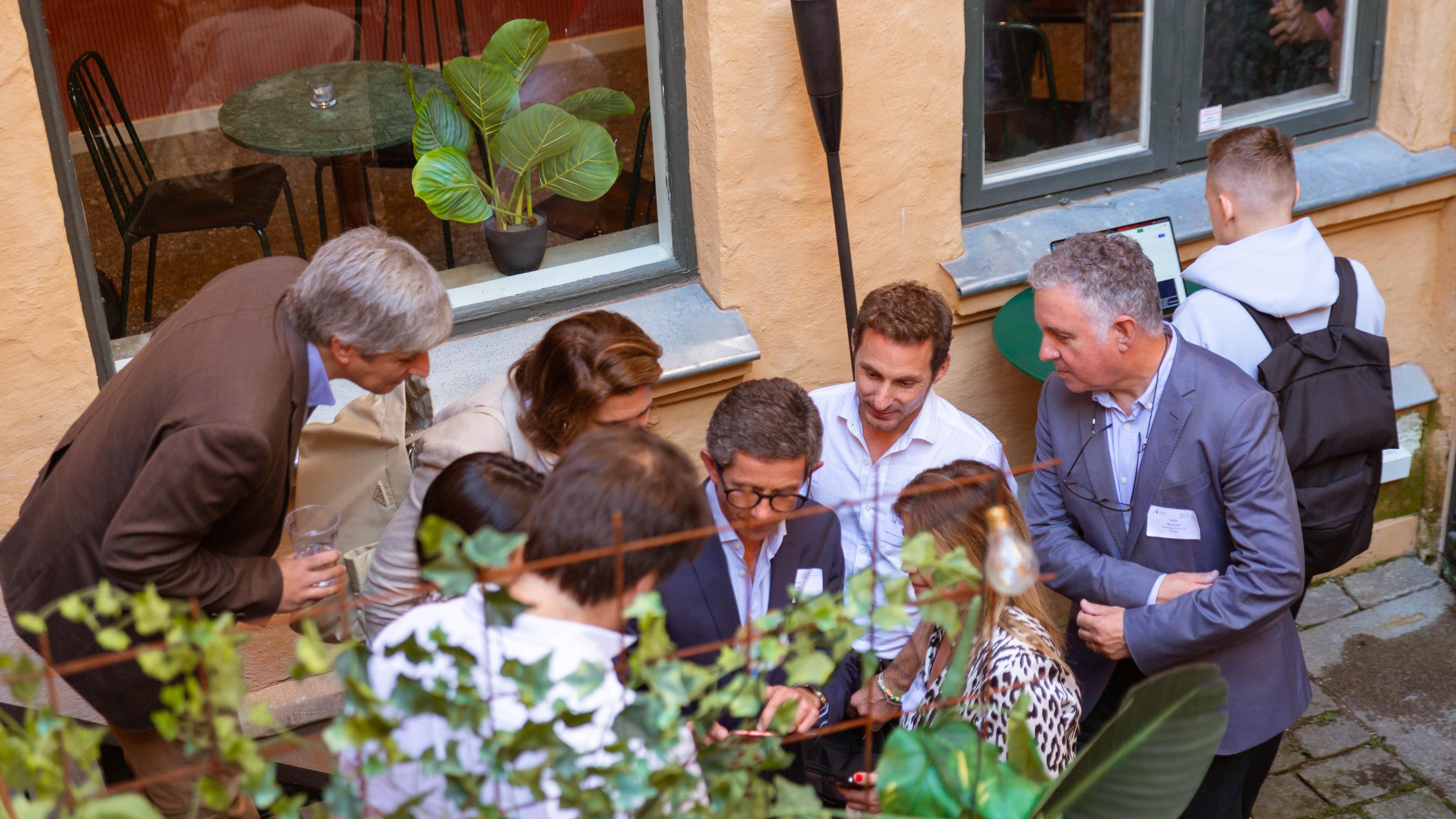 People talking in the backyard at the event