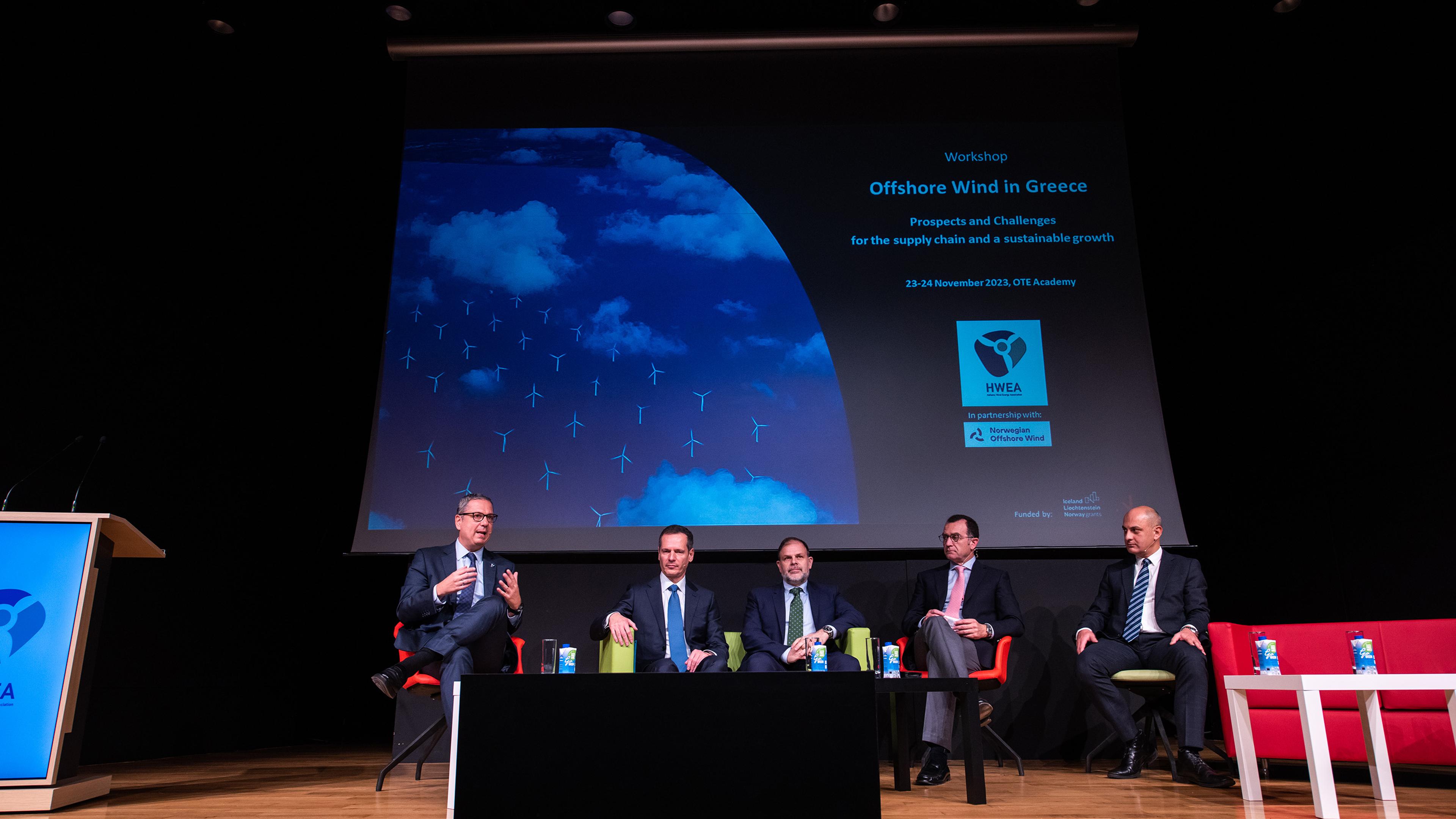 A photo of five men discussing offshore wind in greece on a stage