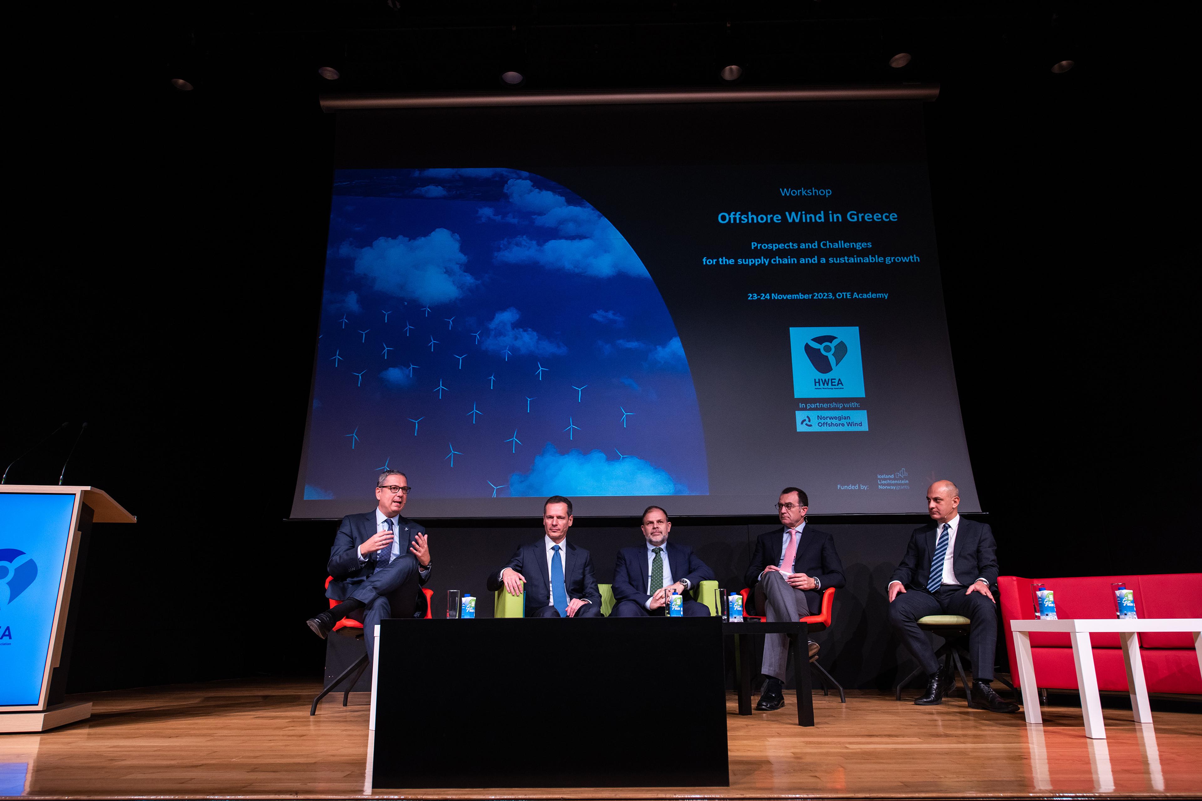 A photo of five men discussing offshore wind in greece on a stage
