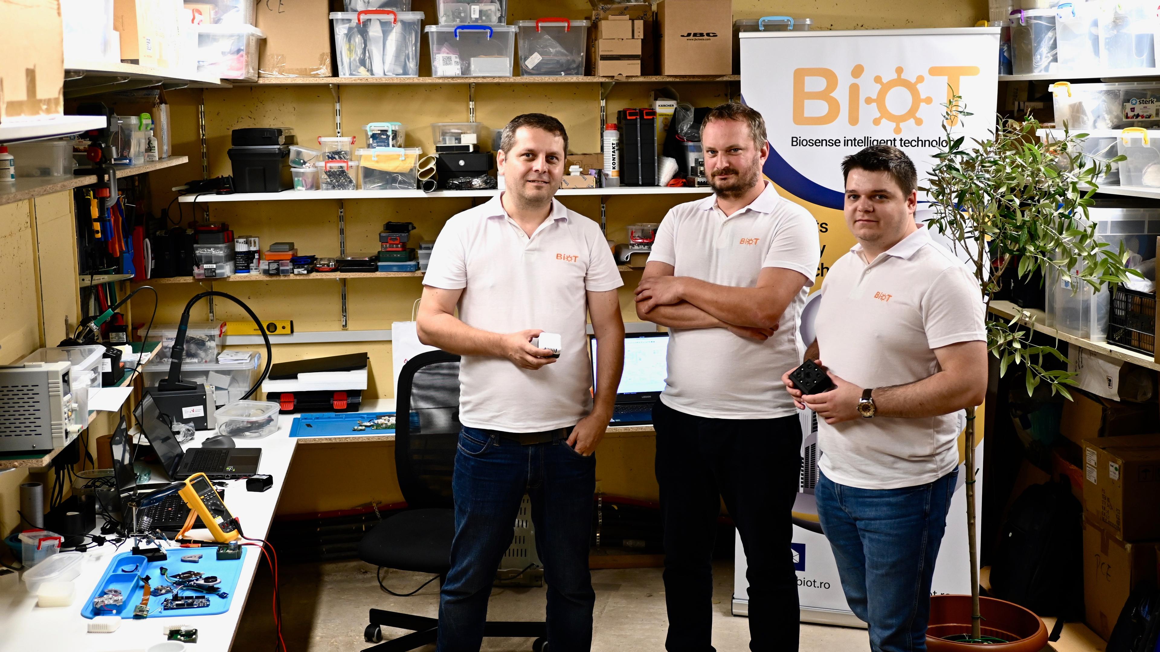 Three guys smiliing in the BioT lab