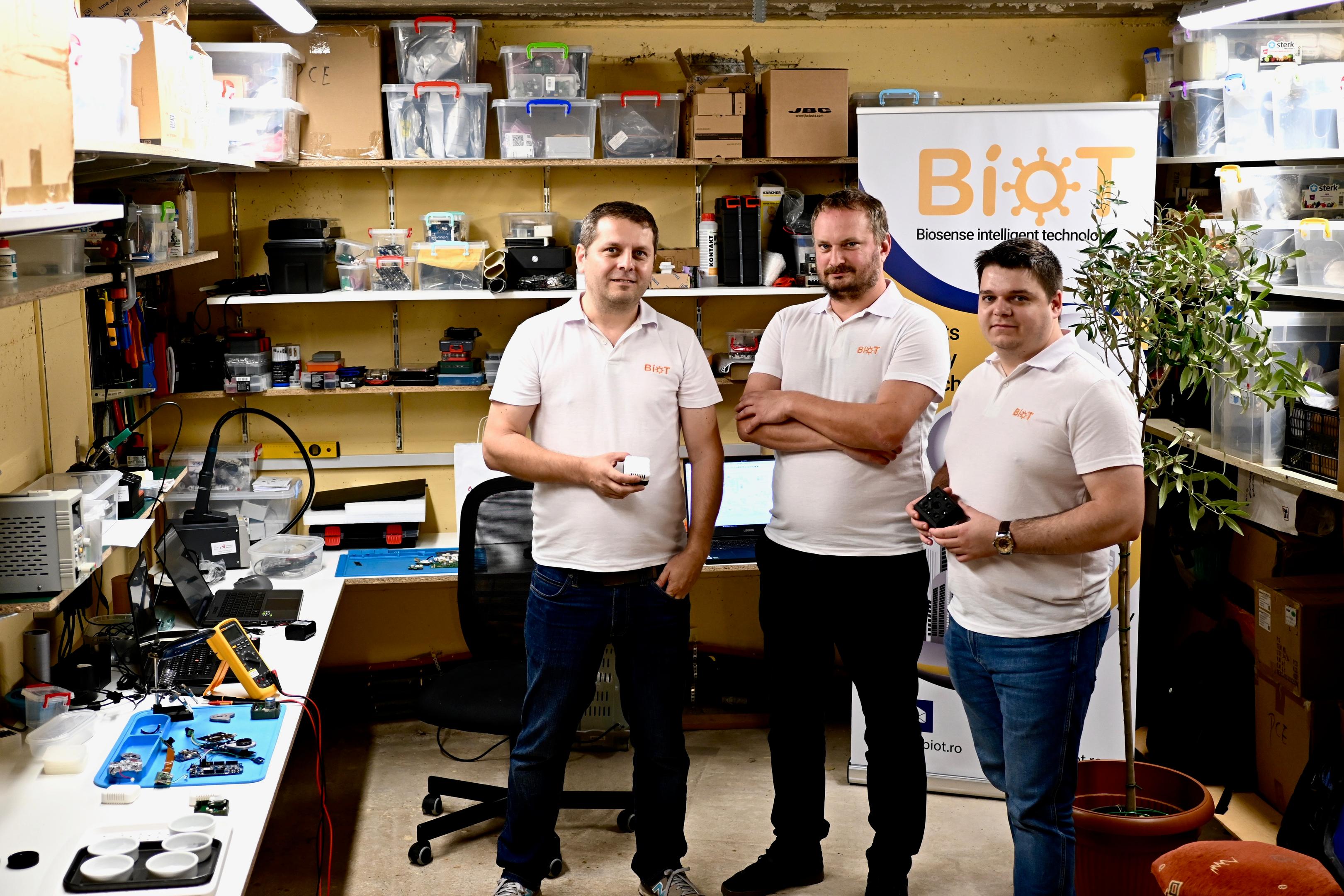 Three guys smiliing in the BioT lab