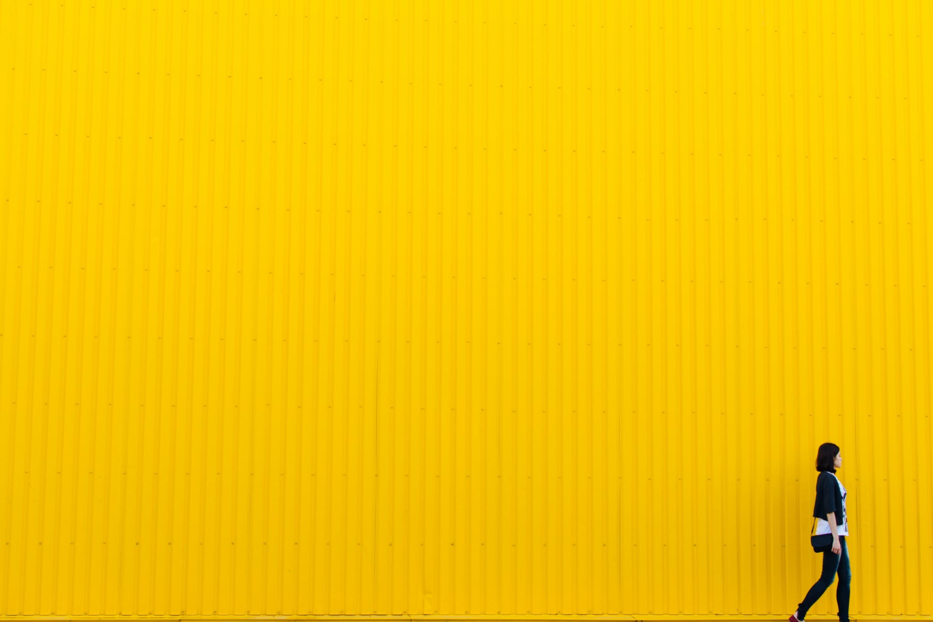 Woman in front of yellow wall 