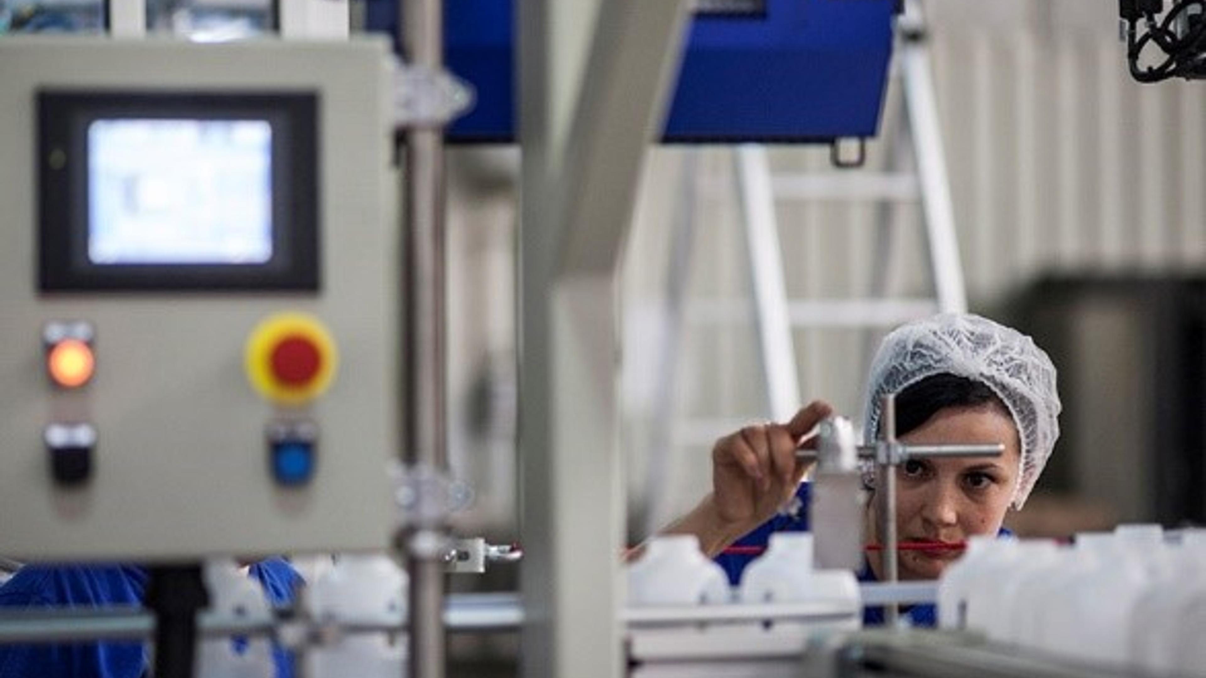 Woman working on an industrial machine