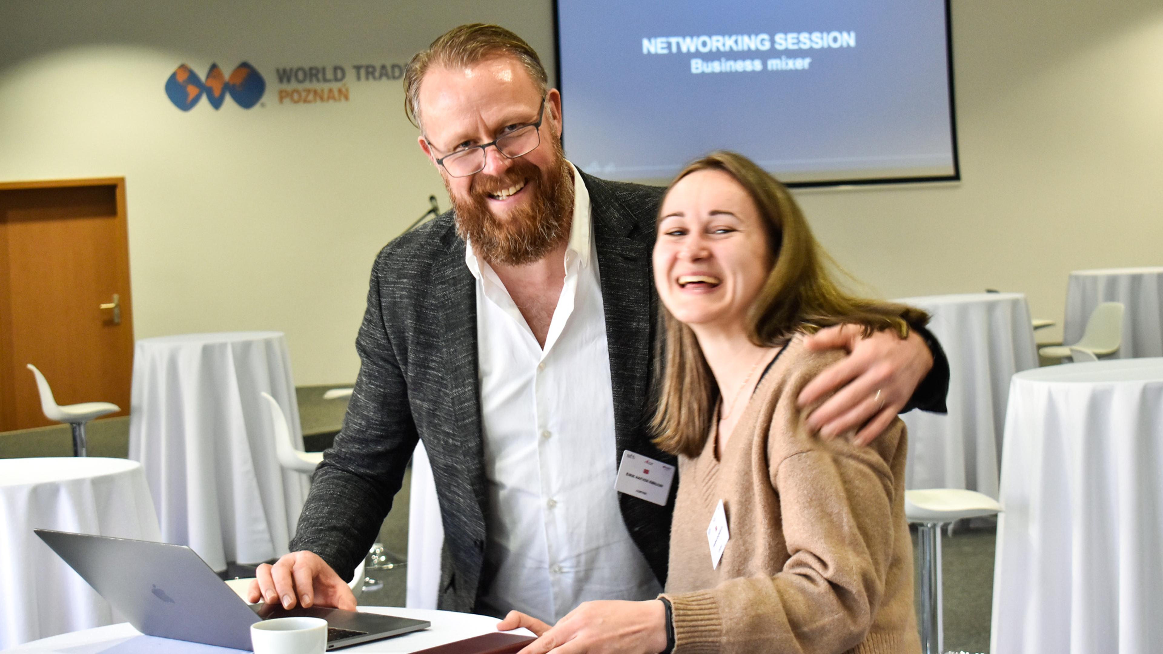 Two people enjoying themselves at a conference