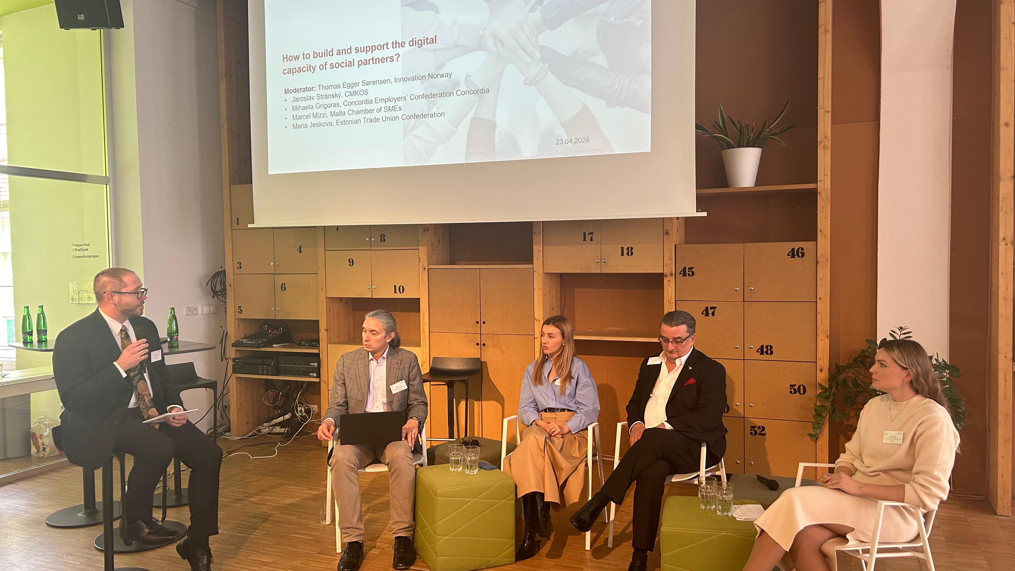 The panellists of the first panel having a discussion