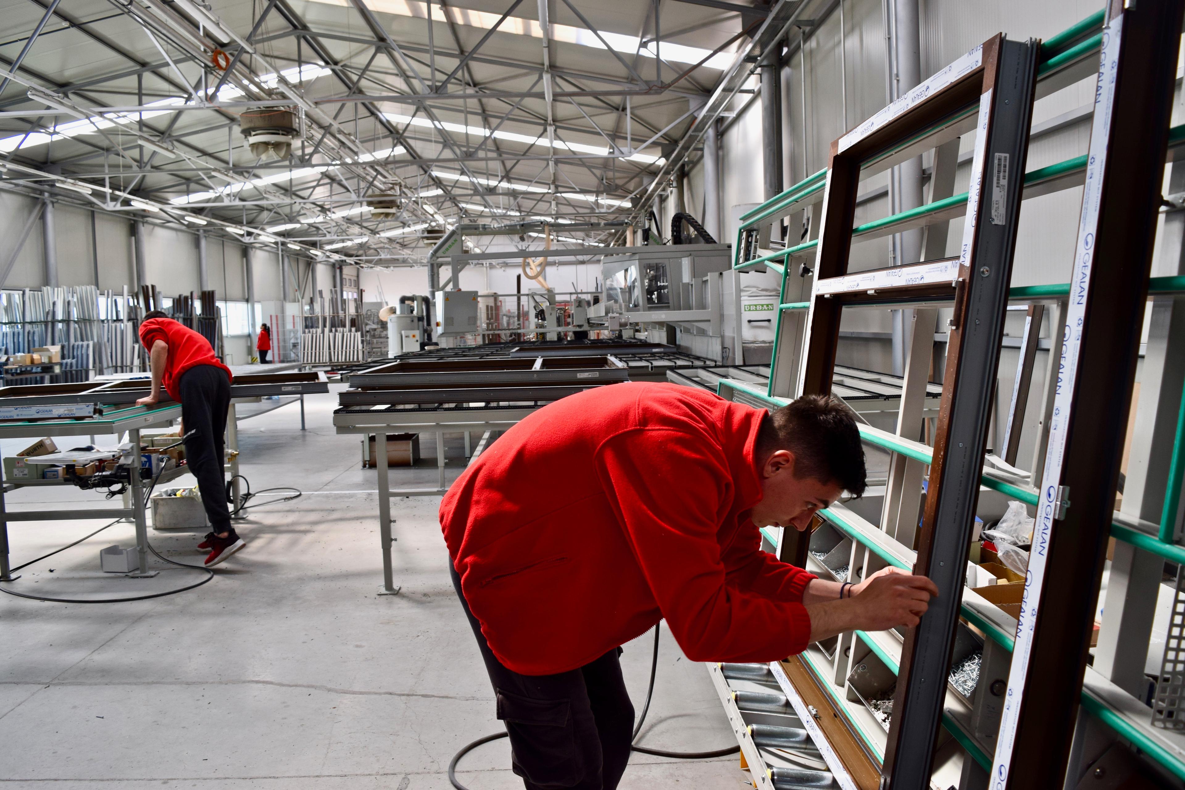 Two people in red fixing stuff at the storage facilities