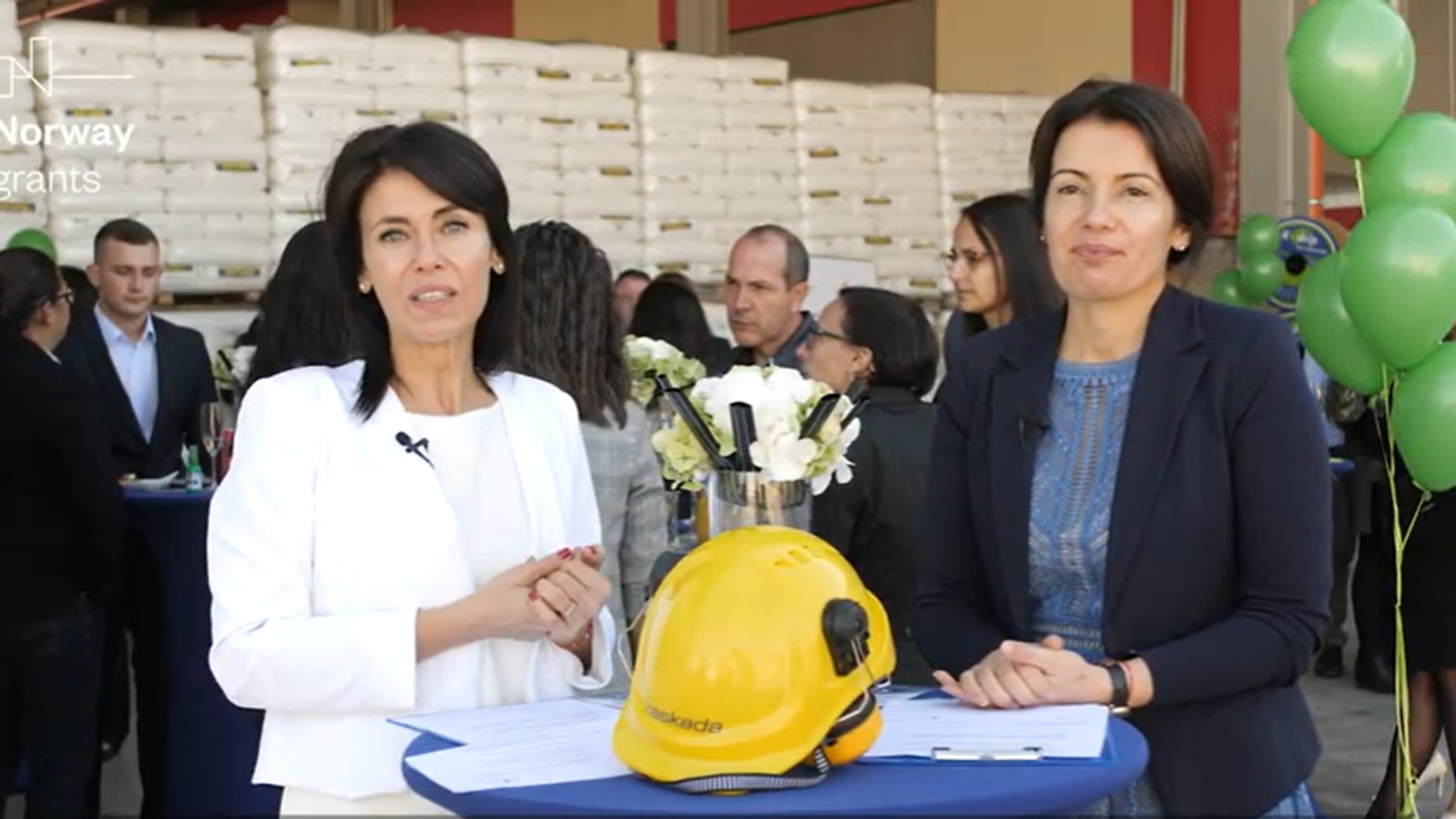 Two business women with industrial helmet