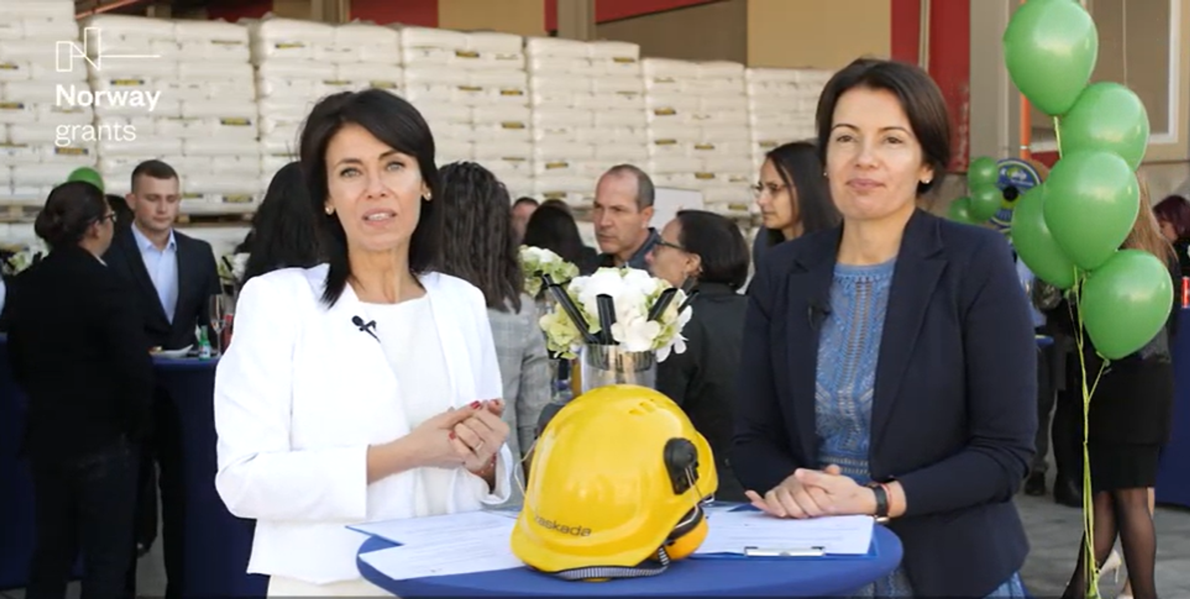 Two business women with industrial helmet