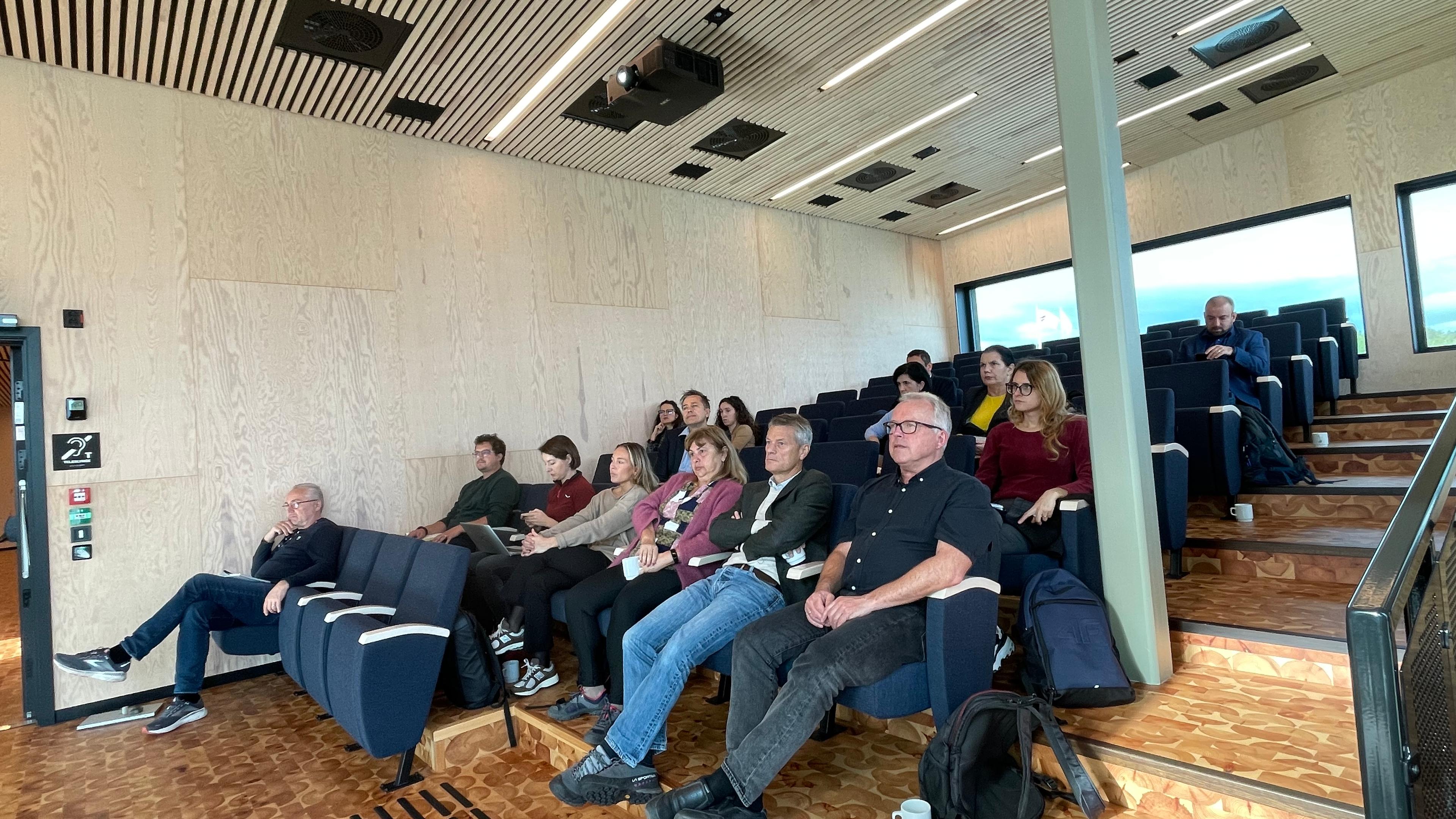 The study group sitting in an auditorium at northern lights