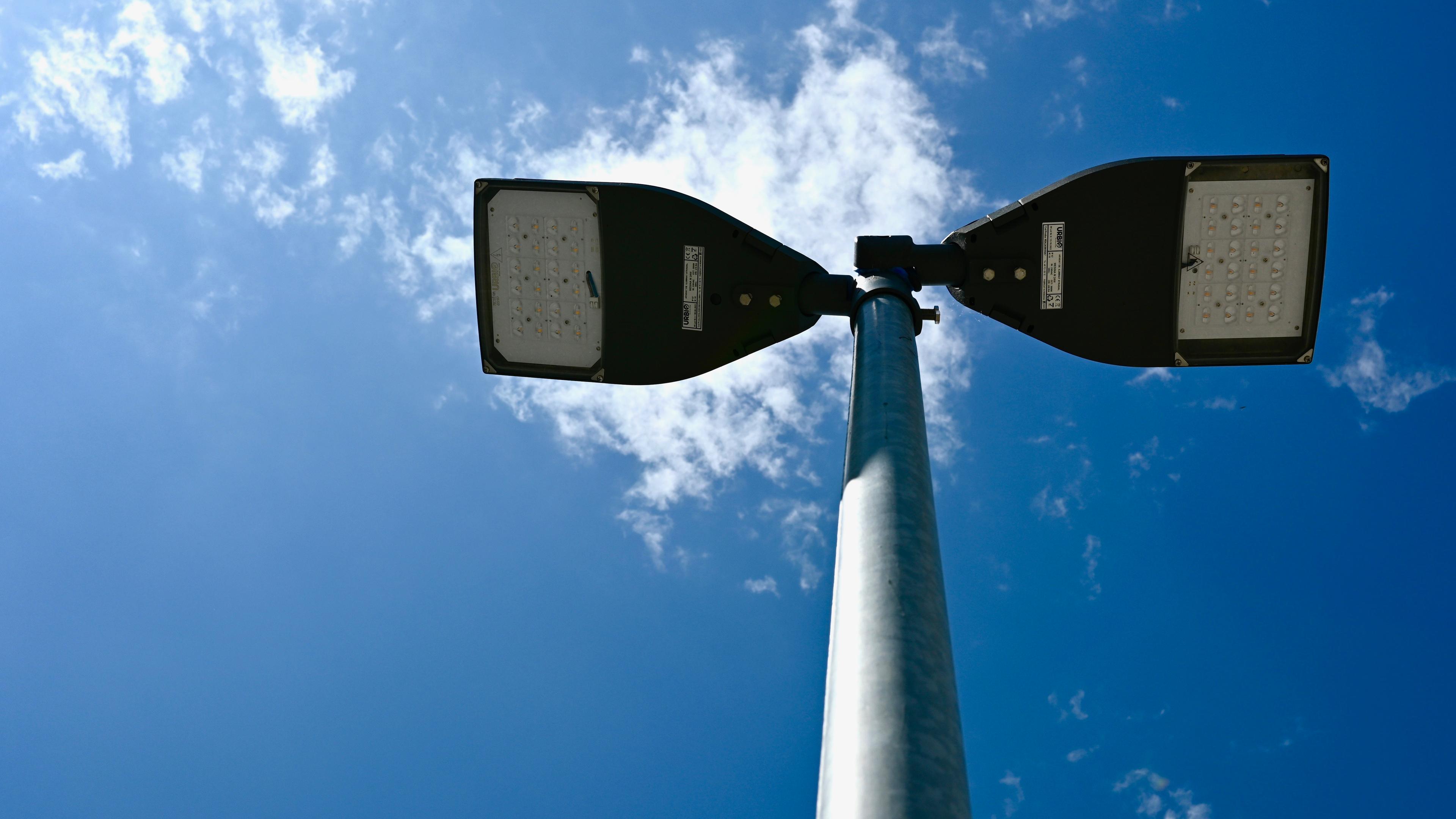 A picture of the street lightning from down below looking up underneath the street lightning, enabling us to see the LED technology used in the street lightening