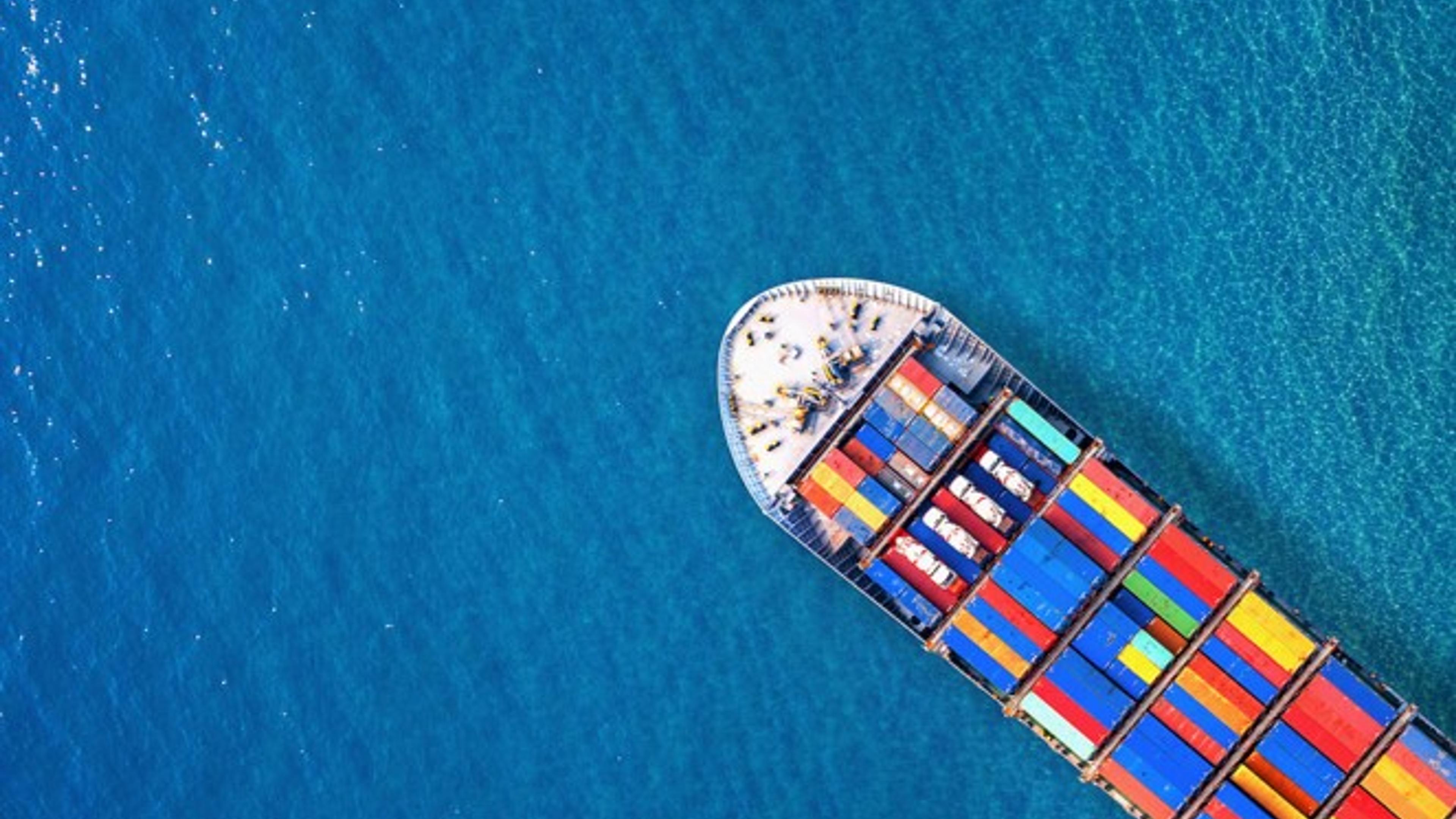 Container ship in ocean seen from above