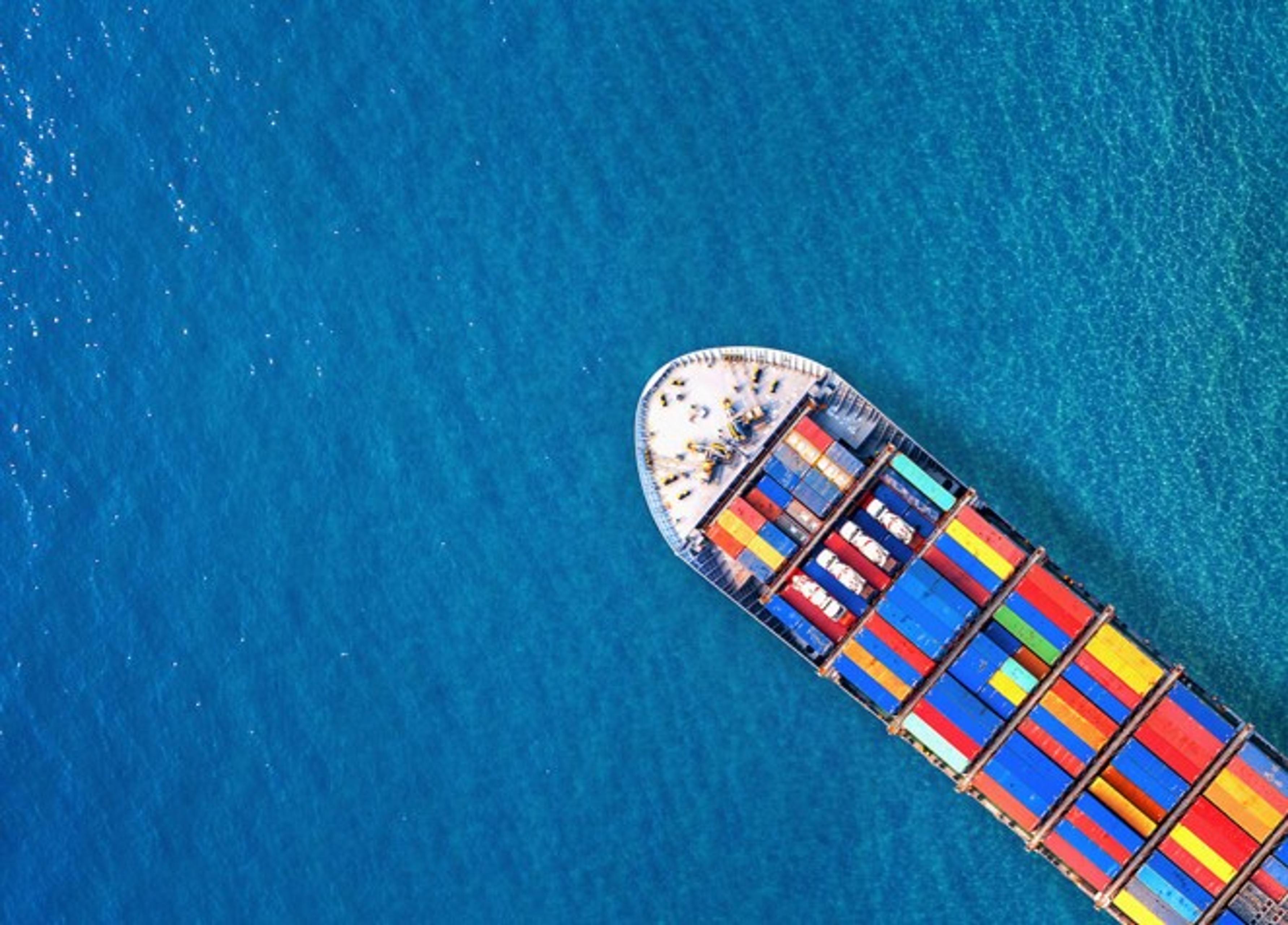 Container ship in ocean seen from above