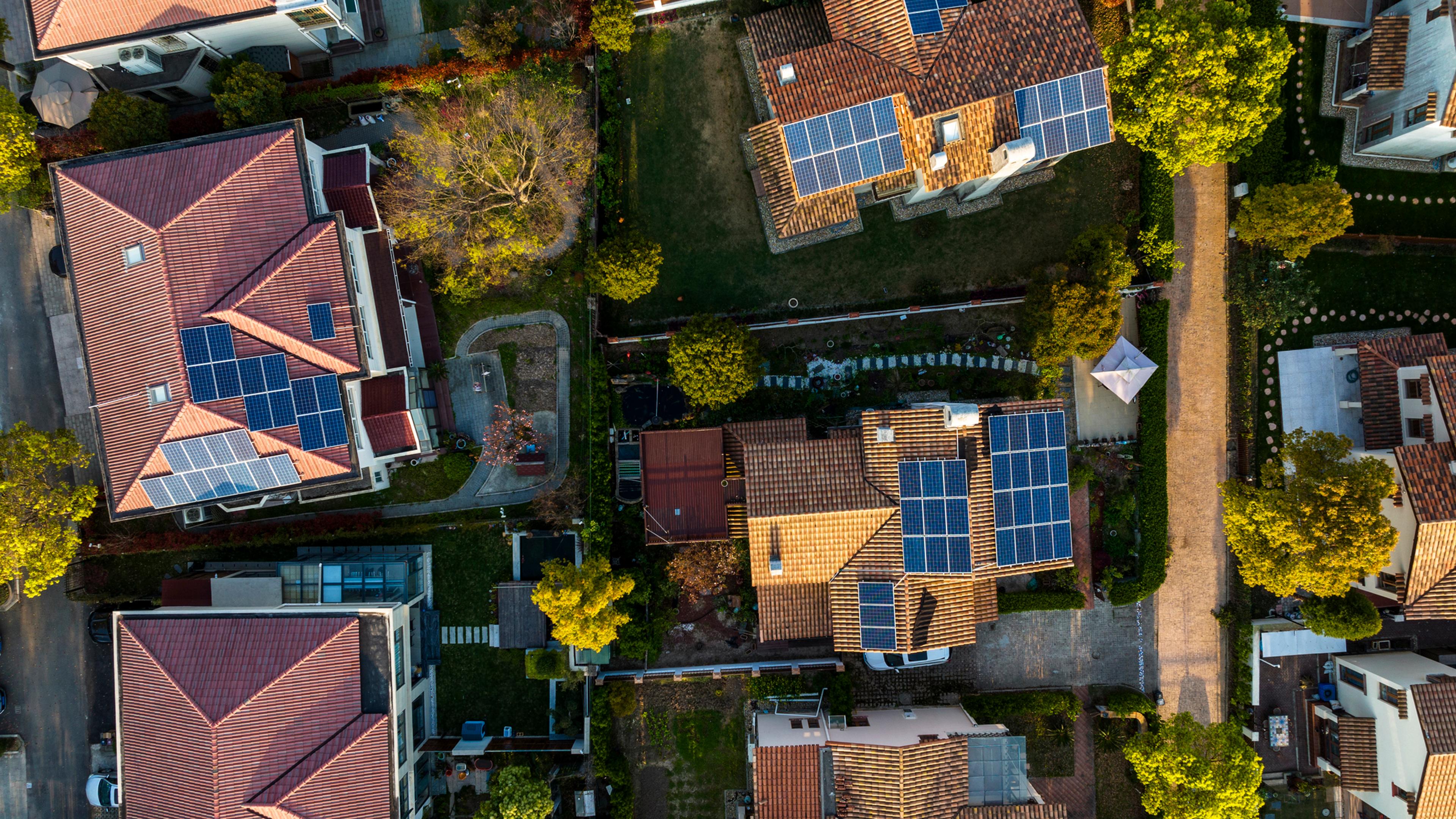 Modern houses with solar panels for energy storage.