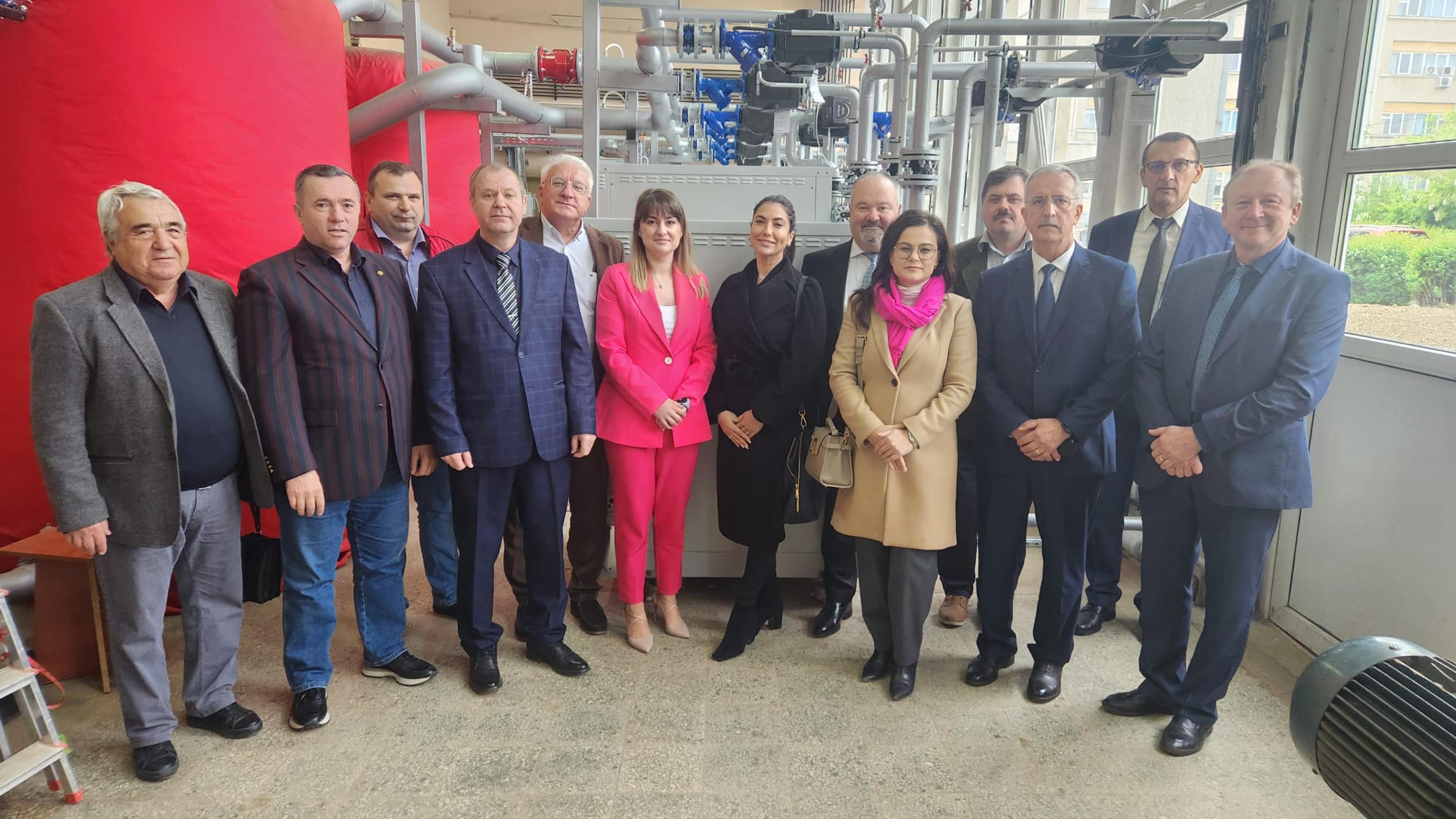 A photo of a group at a study visit on geothermal in front of technical equipment