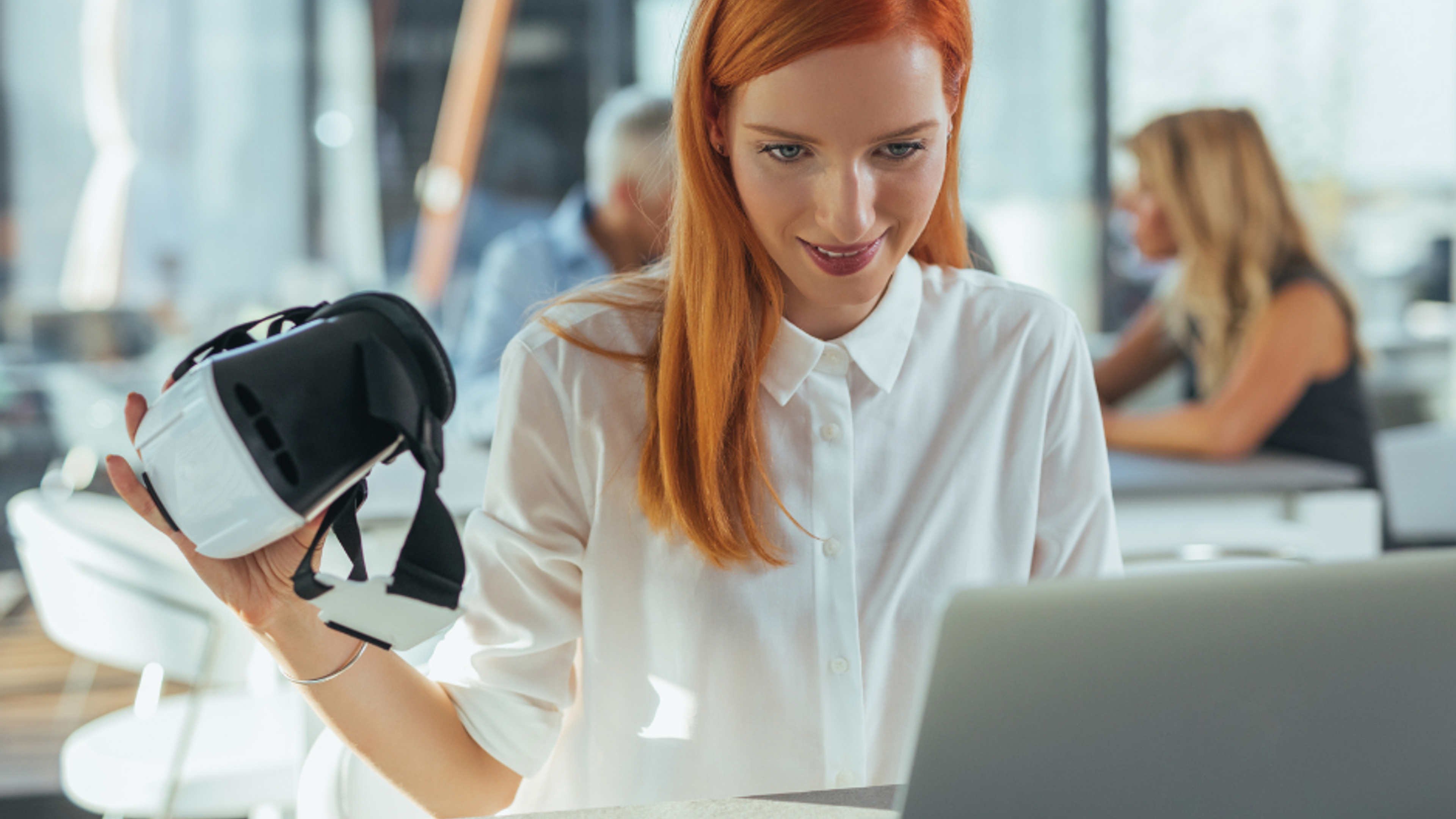 woman on computer with VR set