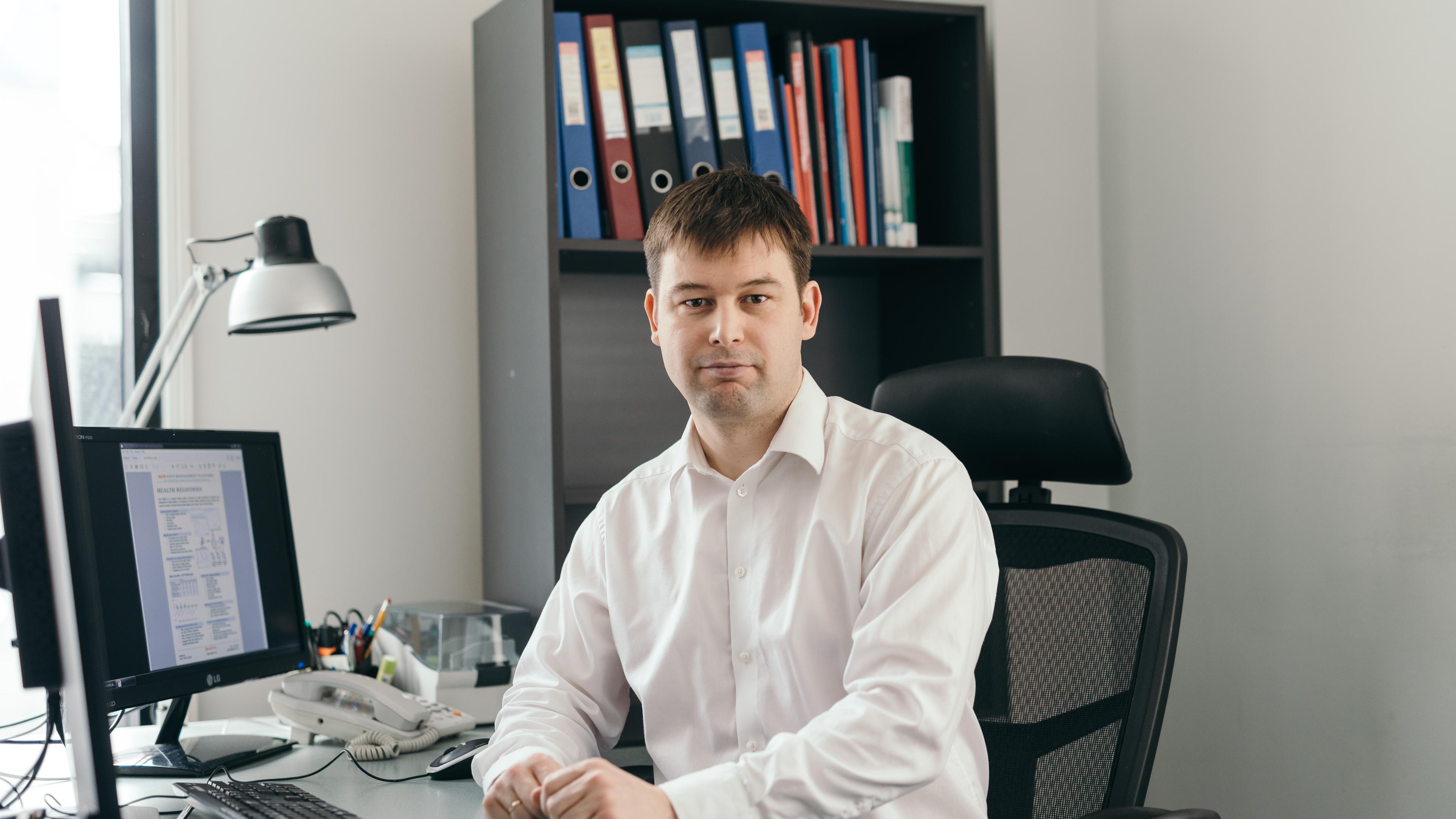 Man sitting by his office desk