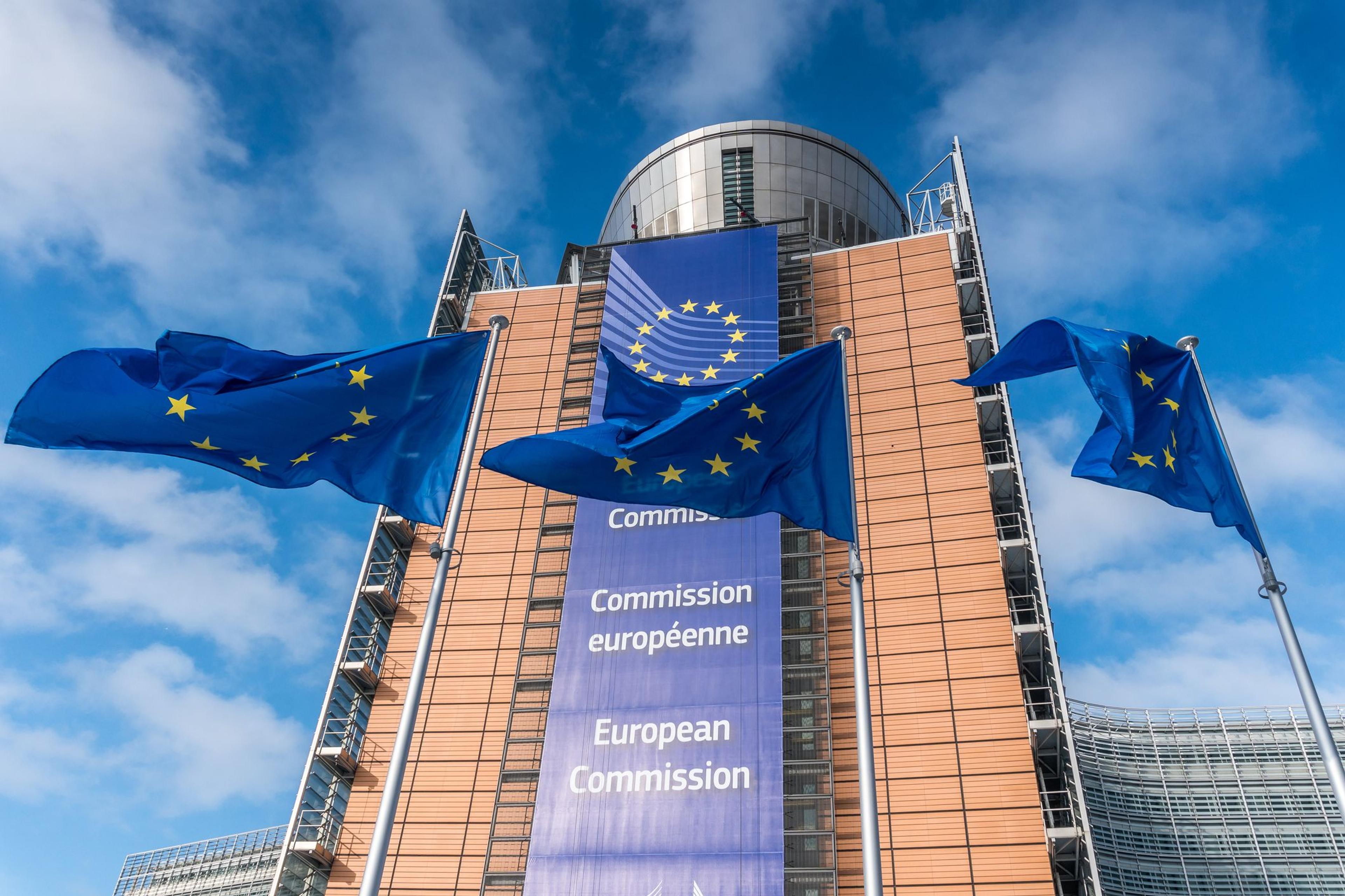 European Union flags waiving in front of Berlaymont building of the European Commission - stock photo