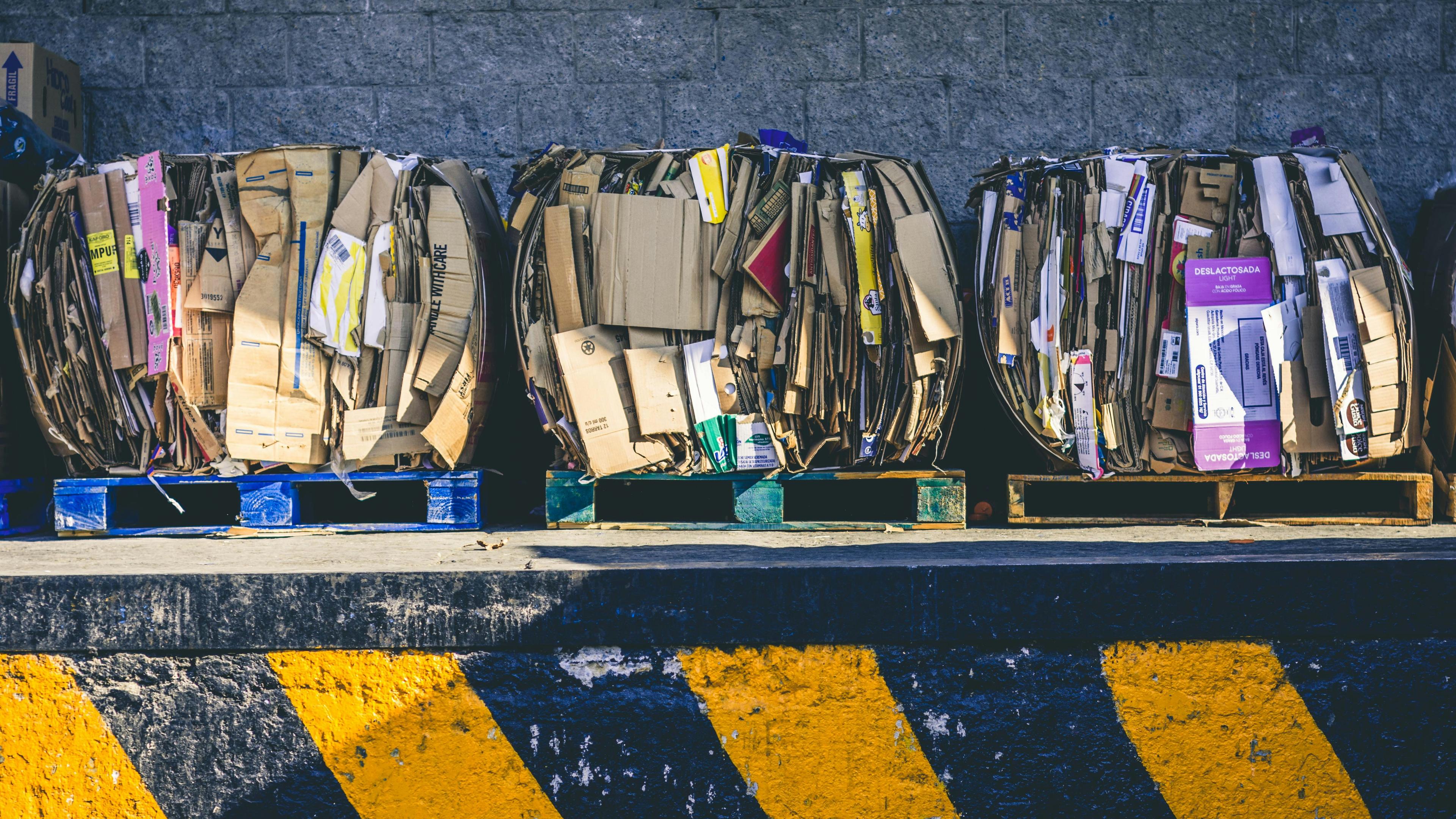 Folded cardboard and paper bound together on pallets