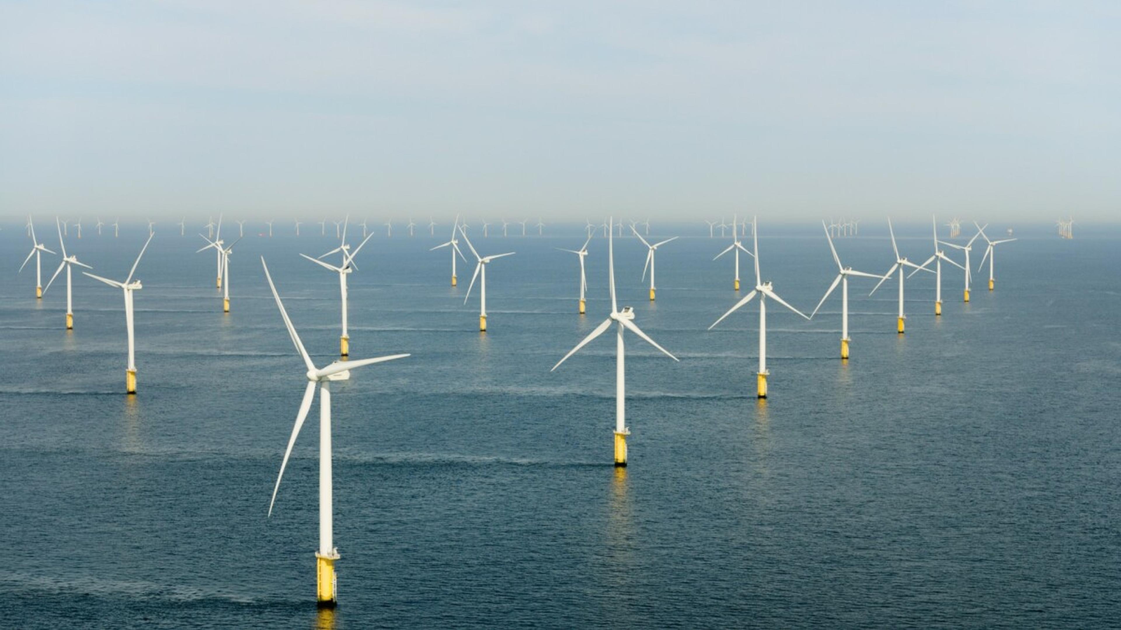 Offshore wind turbines in a row in the sea