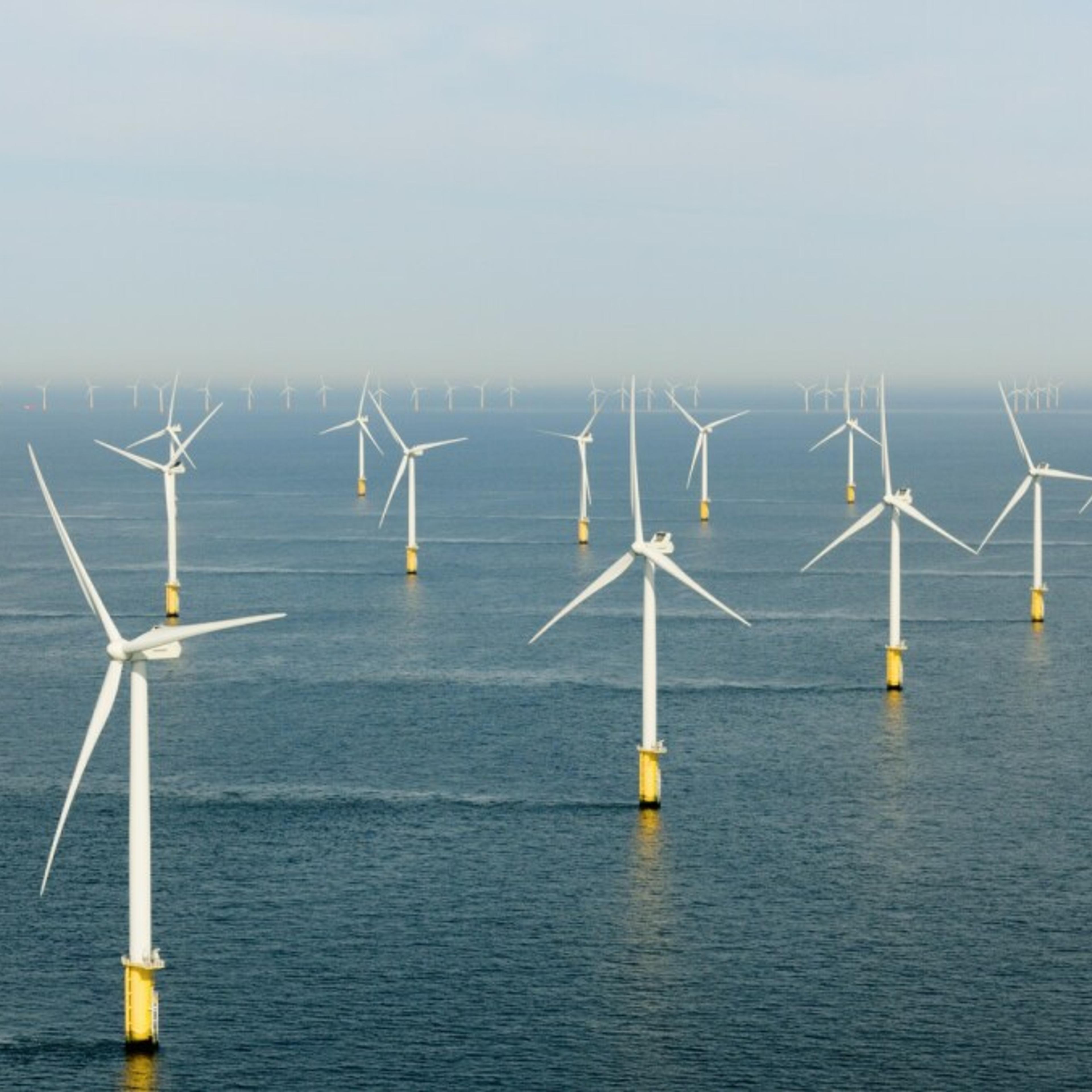 Offshore wind turbines in a row in the sea