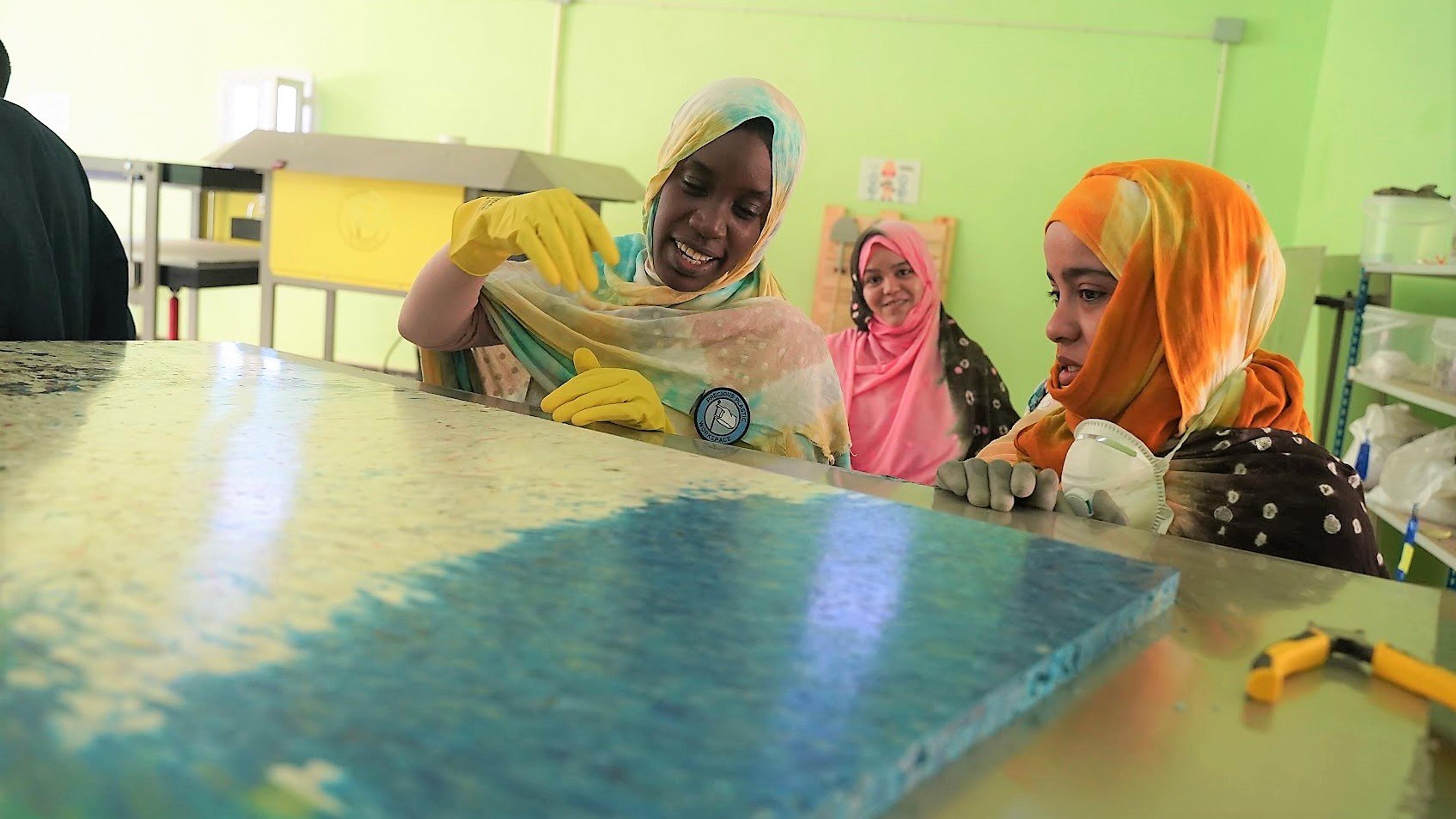 Girls recycling plastic