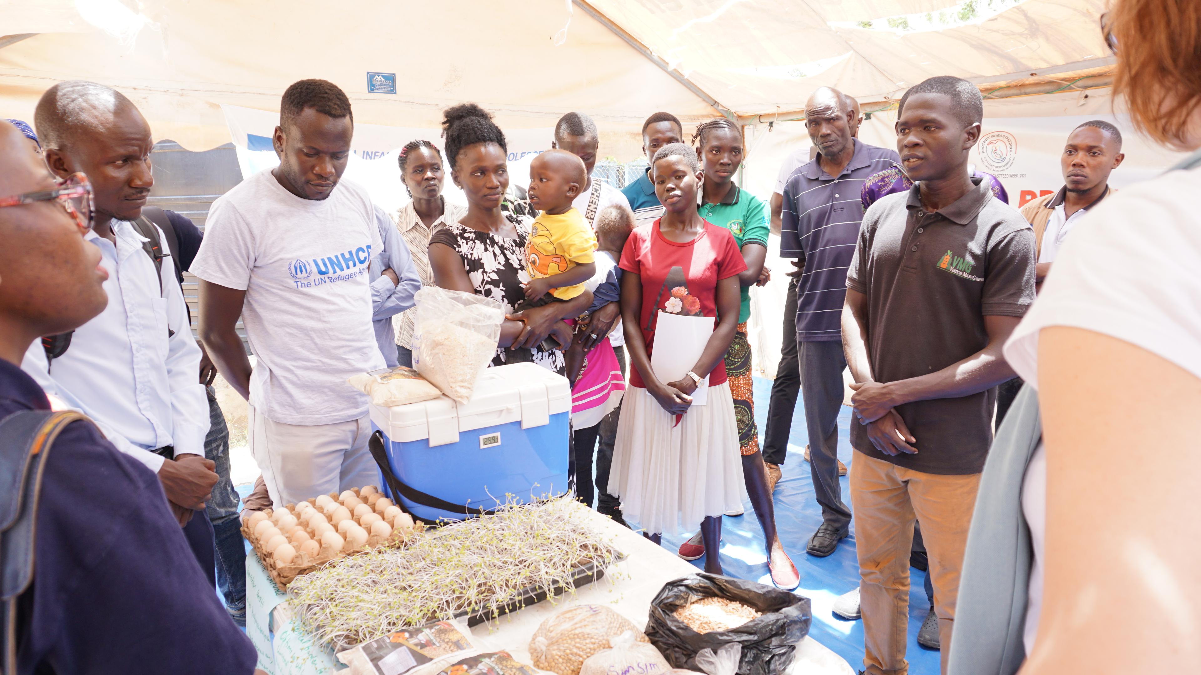 People standing around a table filled with micro greens and other nutrition innovations