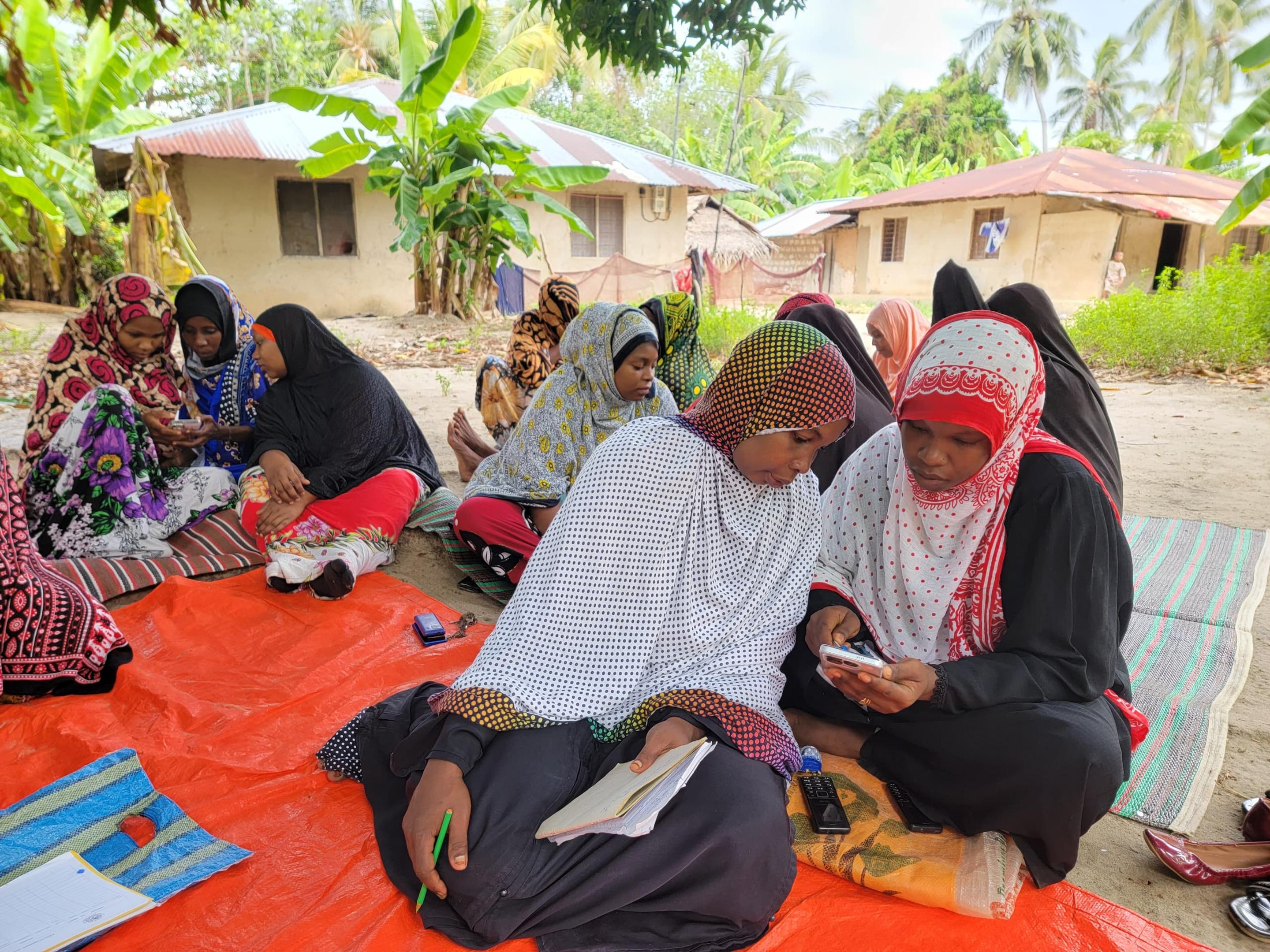 Women testing a digital platform on smartphones
