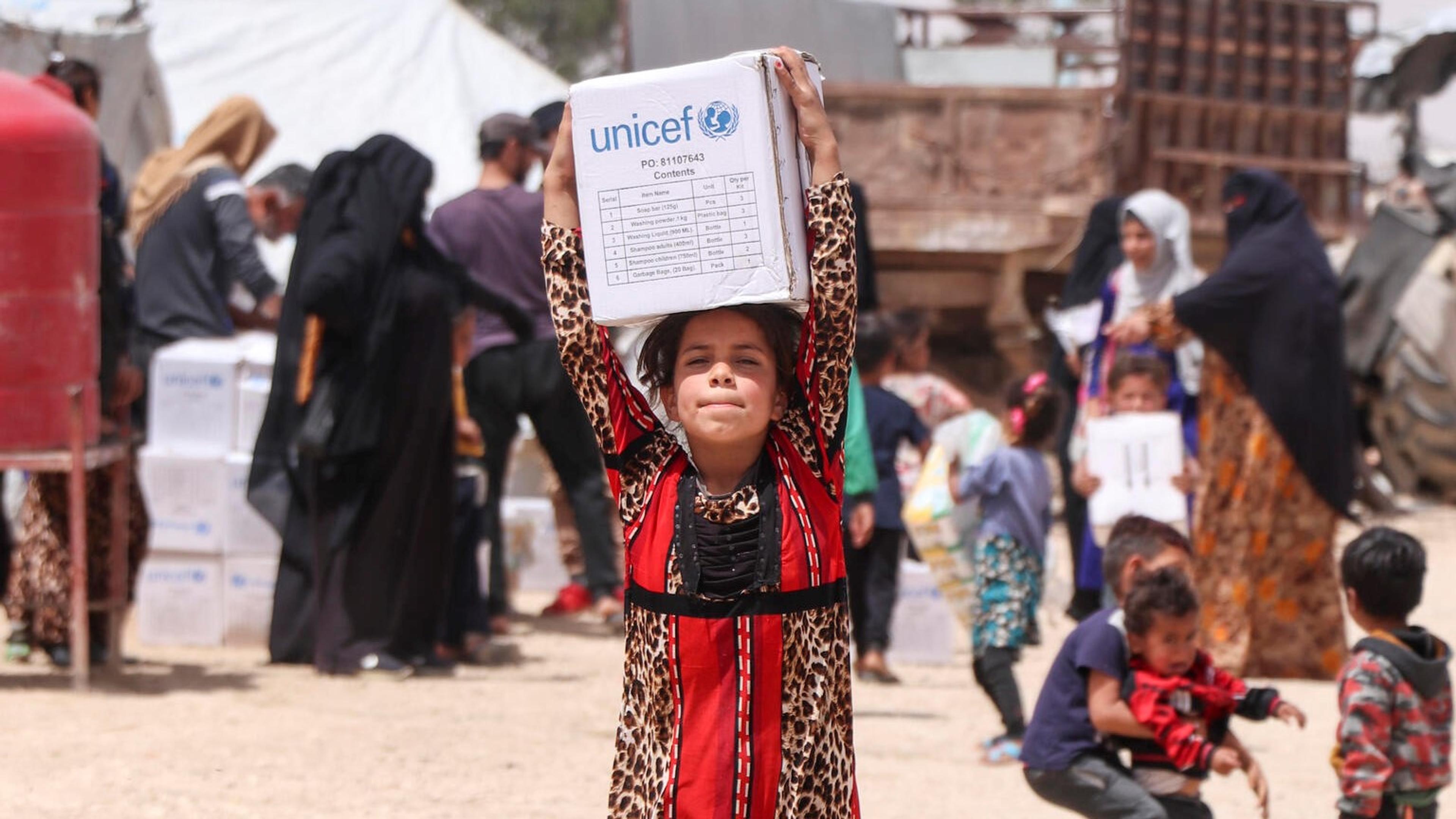 Child with humanitarian aid kit