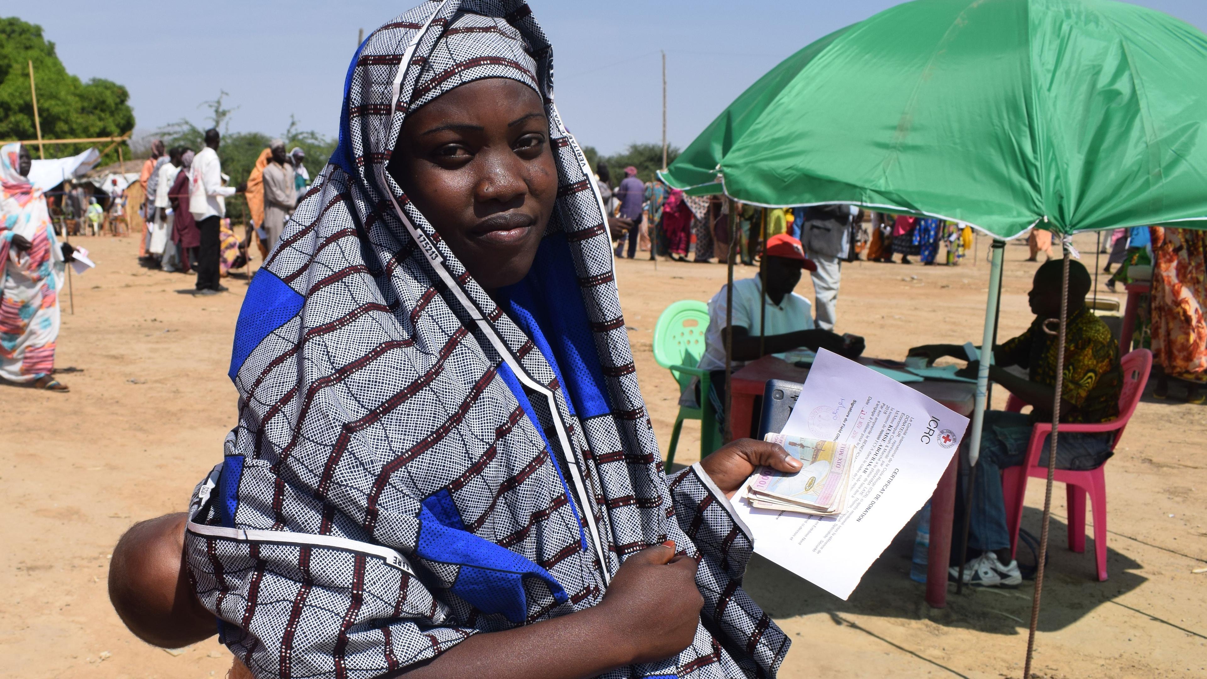 a young mother receiving cash assistance in the town of Makary in the Far North Region of Cameroon