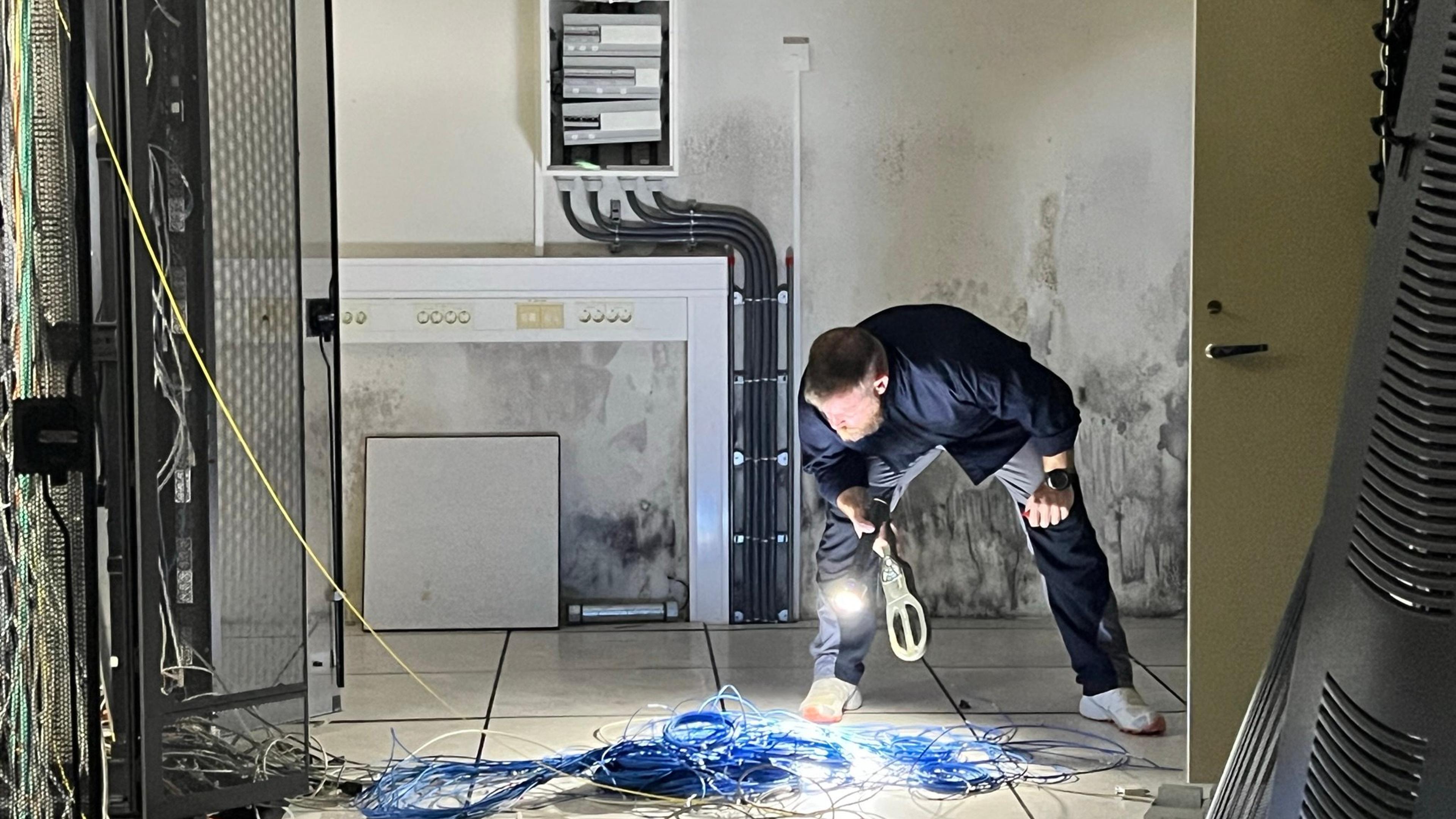 Man testing new tools for mine clearance in basement