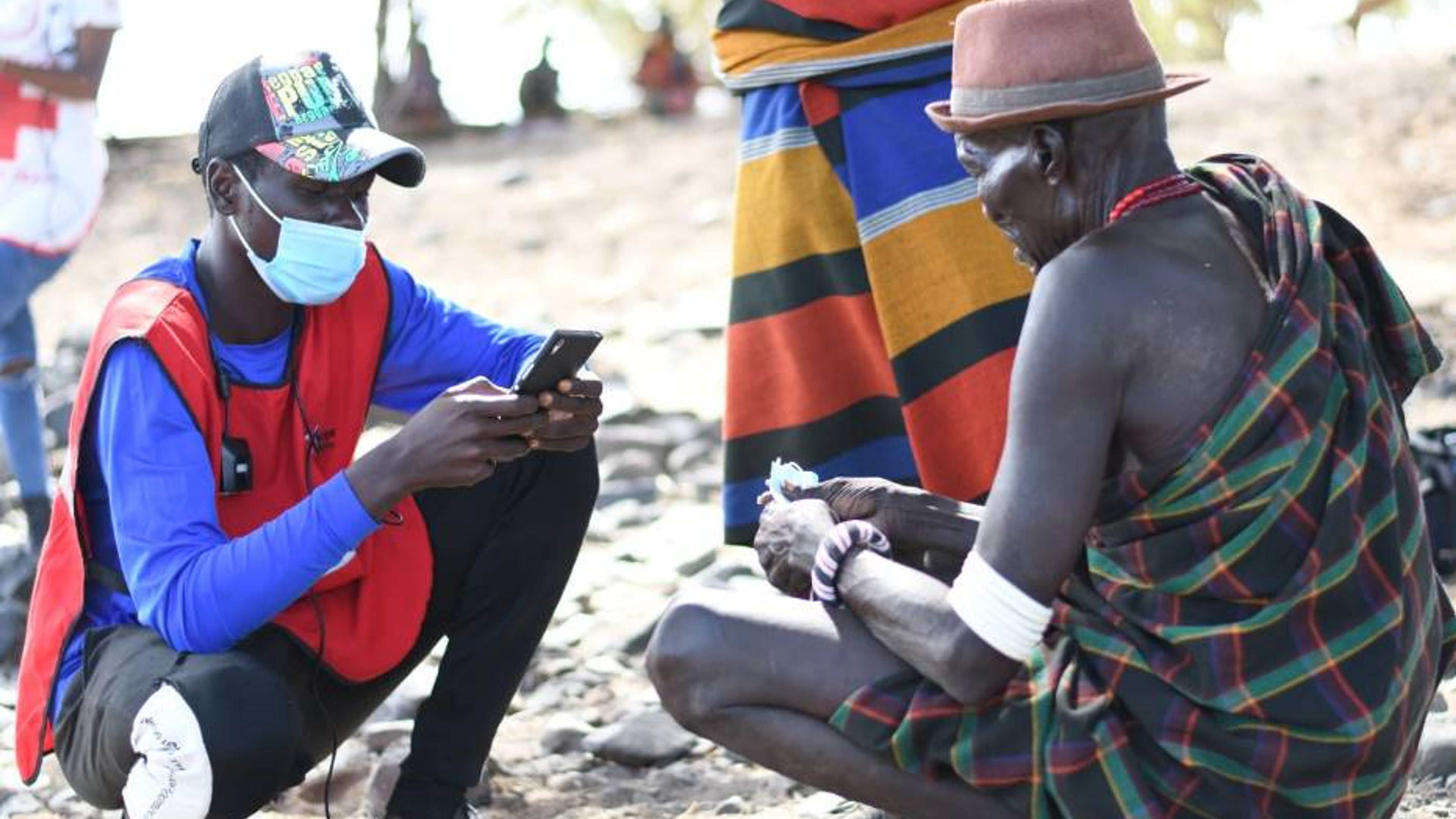 Man registering to receive cash assistance in Uganda