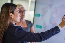 to kvinner som peker på verdenskart