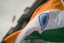 indian flag waving in front of a building