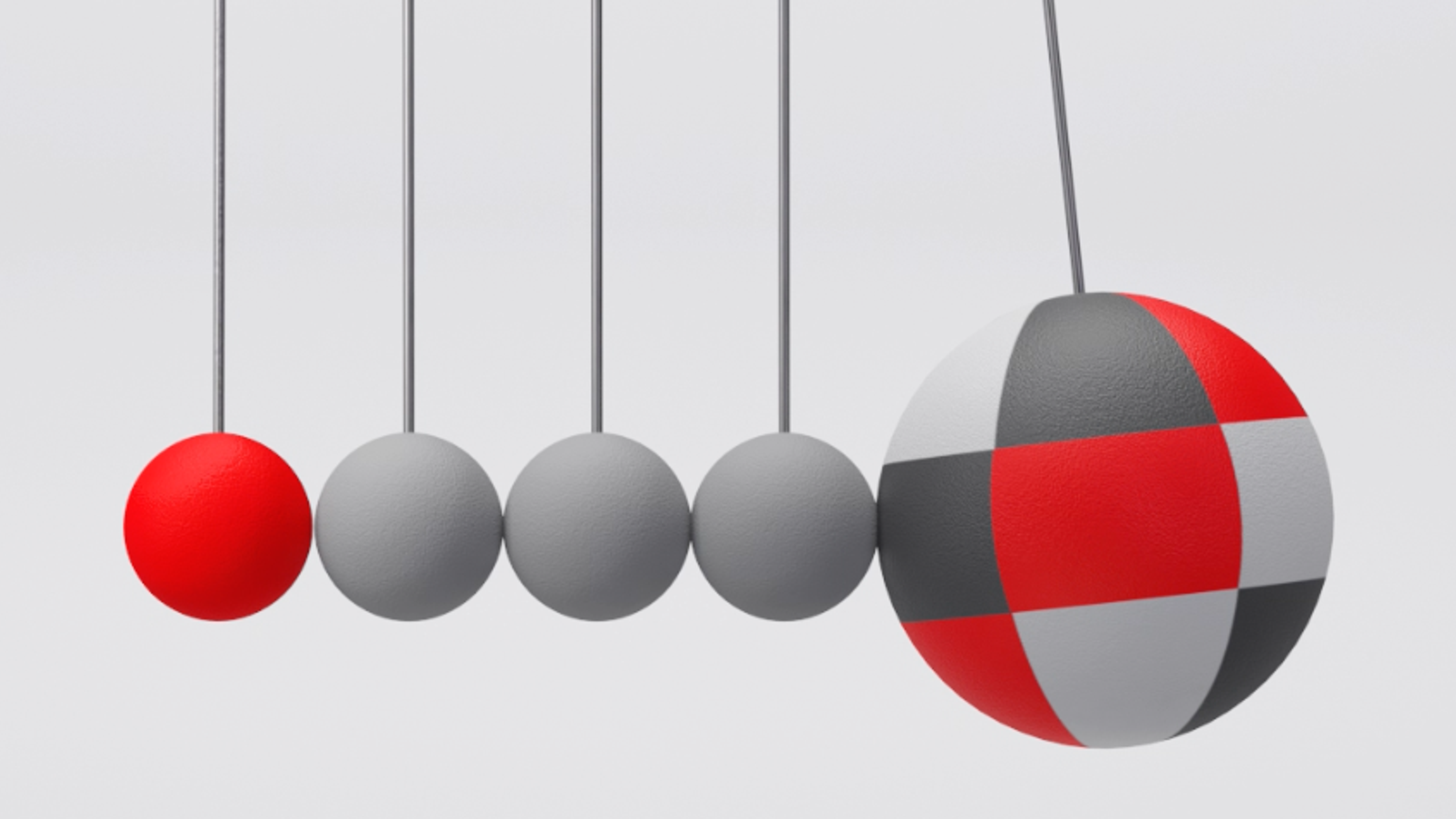 Fem kuler i rødt og grått henger ved siden av hverandre og den største slår inntil den ene for å illustrere bevegelse.
