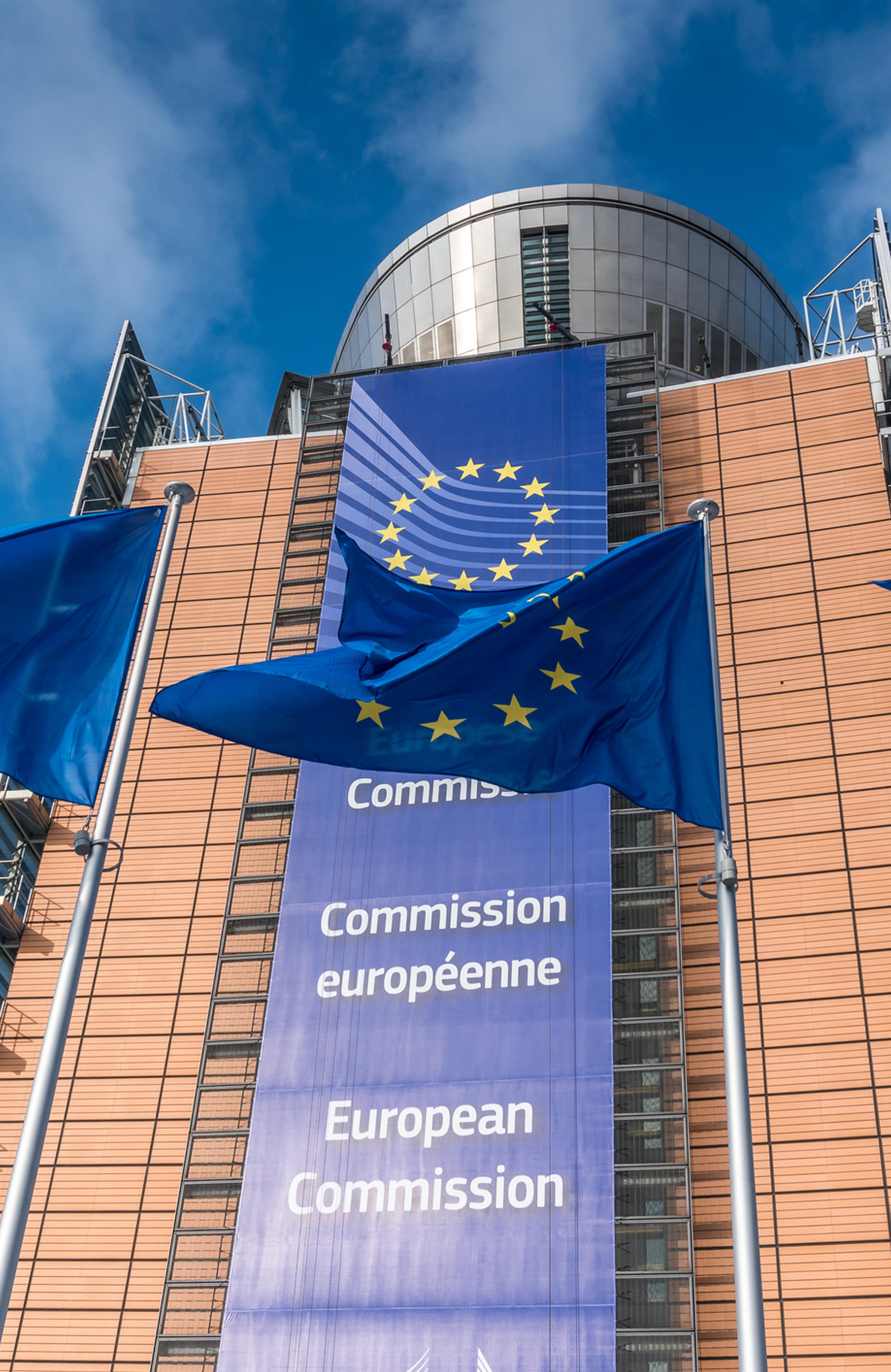 European Union flags waiving in front of Berlaymont building of the European Commission - stock photo