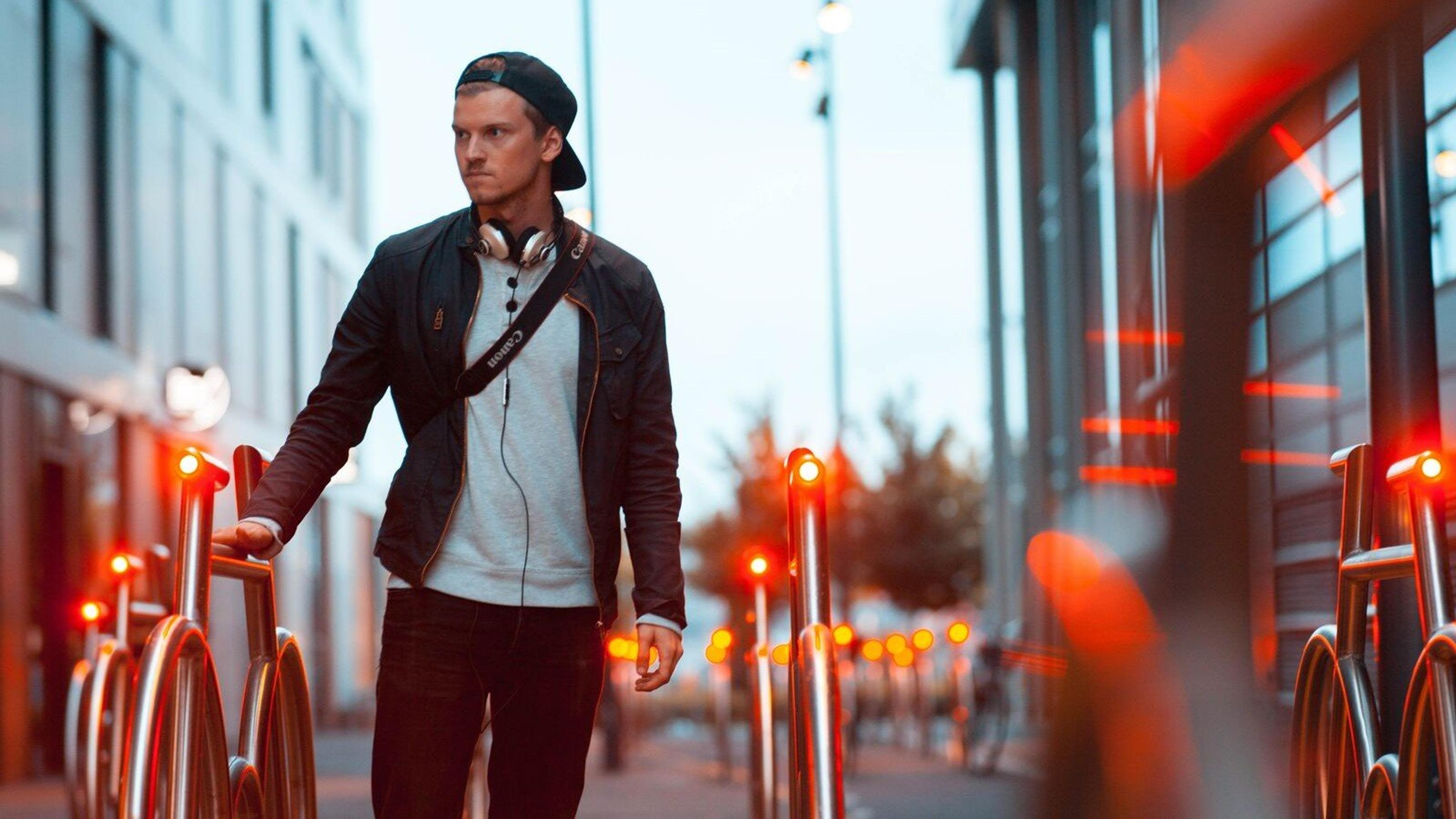 En ung og urban mann ved en smart sykkelparkering i Barcode i Oslo.