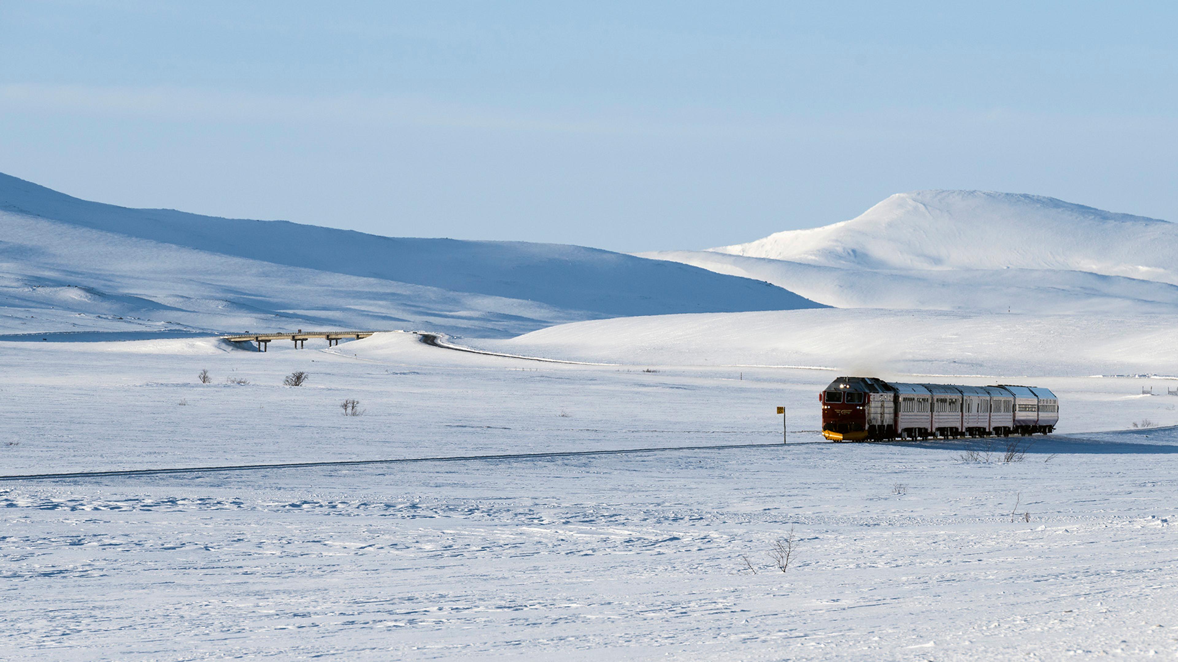 Tog som går i snølandskap