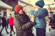 Christmas market at Maihaugen Museum, woman and a little boy smiling