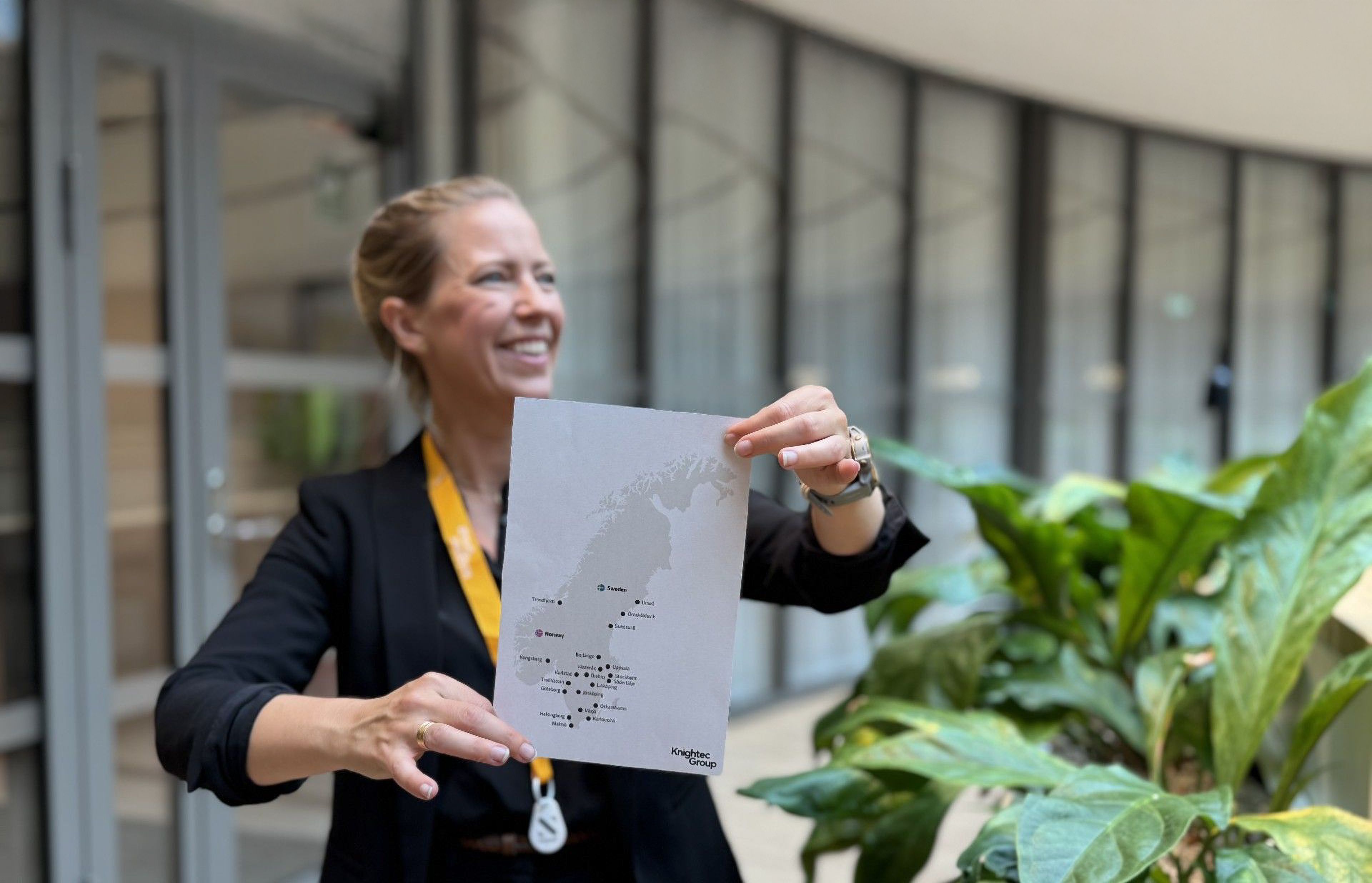 Women smiling in front of a A4 paper