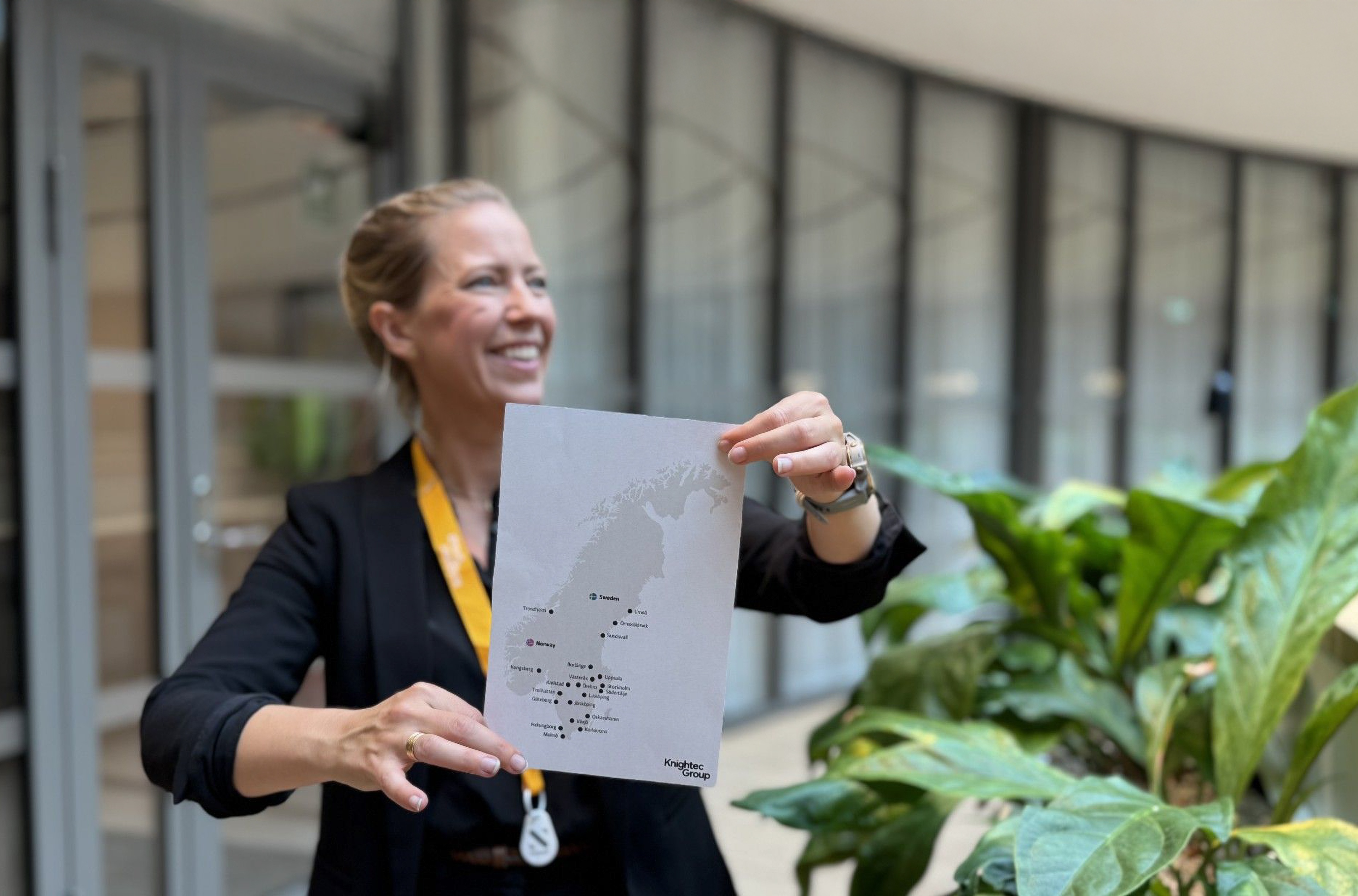 Women smiling in front of a A4 paper