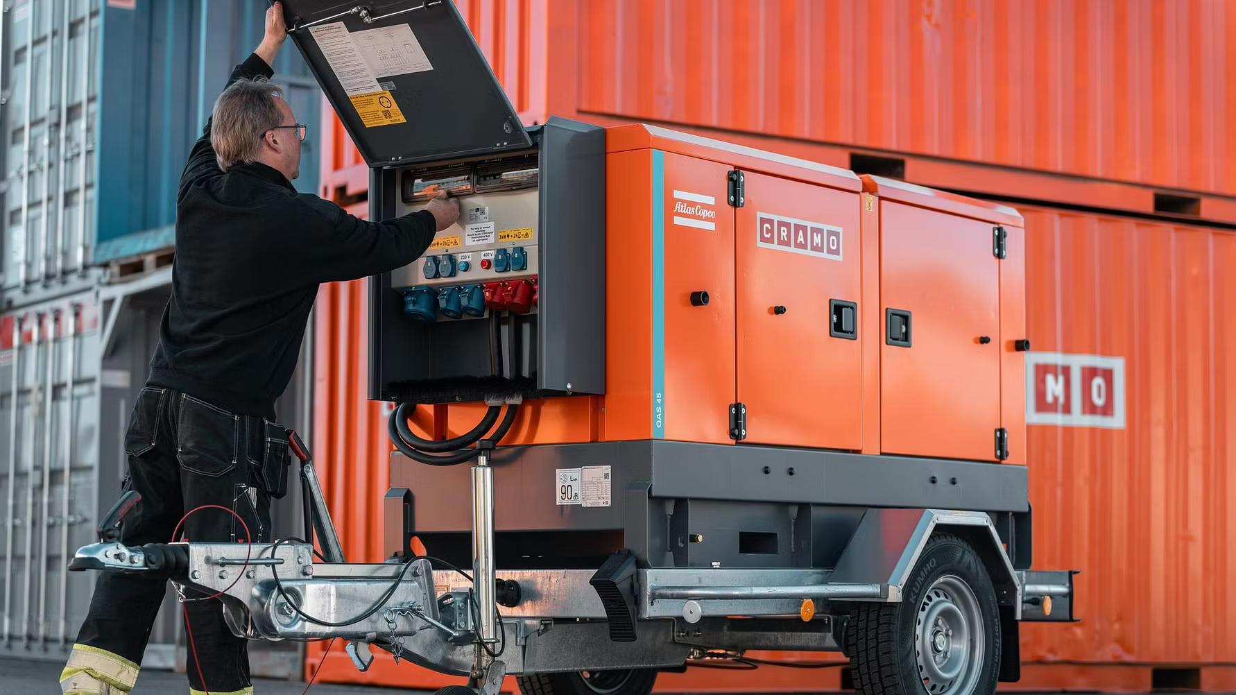 A man standing in front of a Cramo electric central